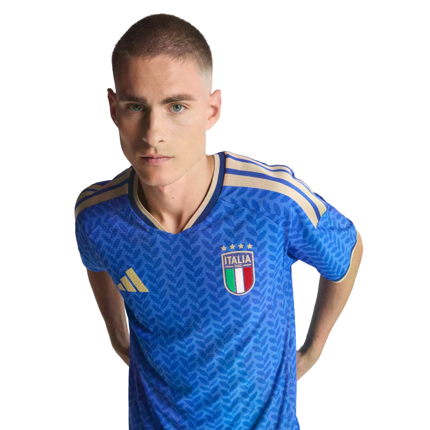 A man wearing a blue Italy national soccer team jersey with gold accents against a black background.