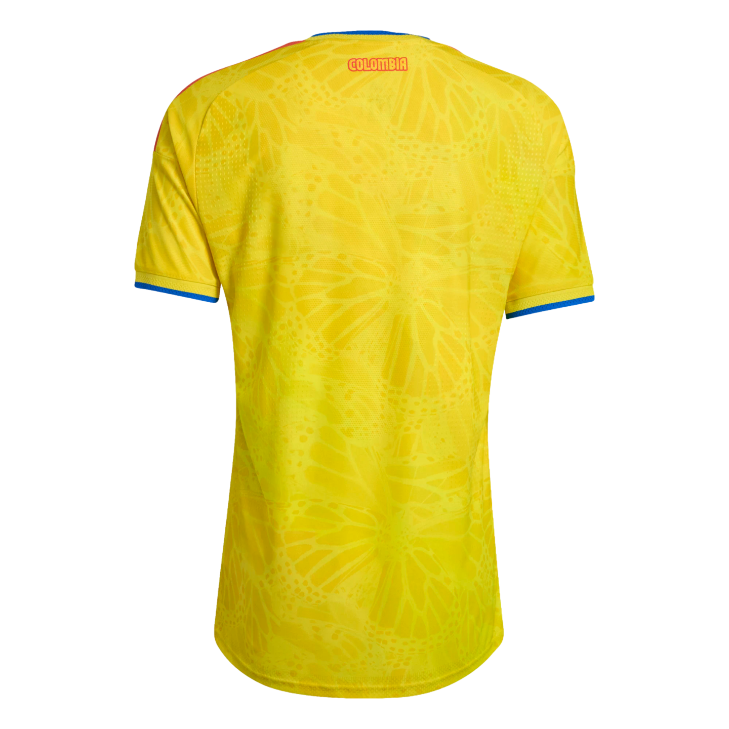Back view of a yellow Colombia soccer jersey with a tone-on-tone butterfly pattern, red "COLOMBIA" text at the neck, and blue-and-red trim on the collar and sleeves.