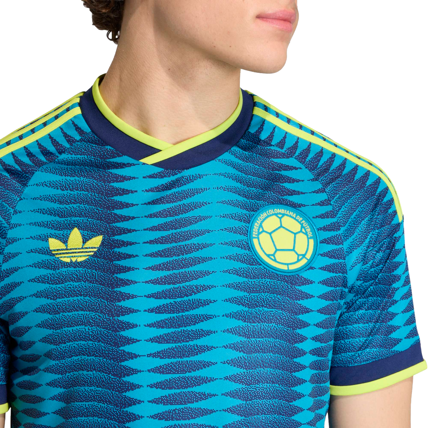 Blue Colombia soccer jersey with a zigzag pattern, yellow Adidas Trefoil logo, and team crest. Features neon yellow accents on the collar and sleeves.