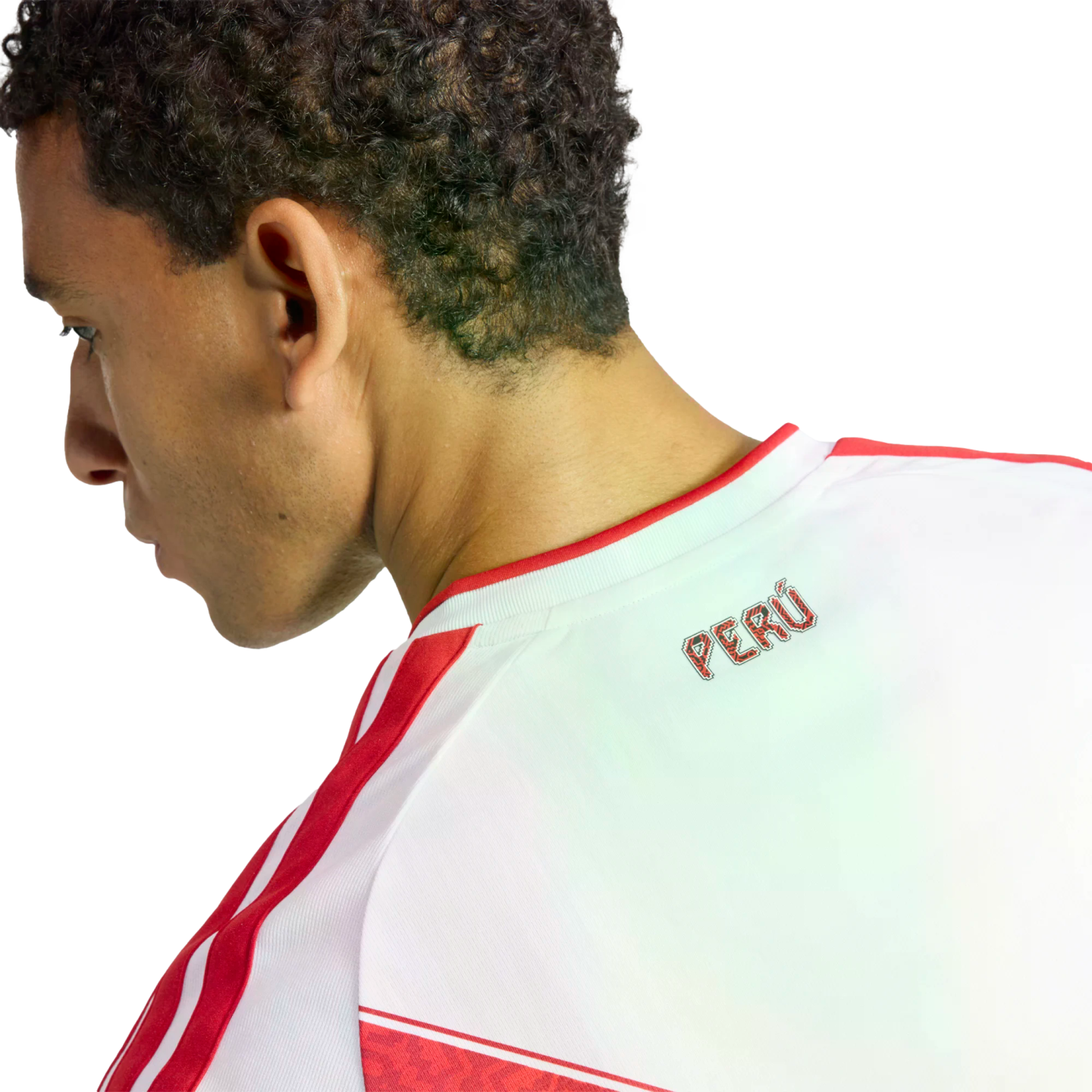Profile view of a man wearing a white Peru national team jersey with red stripes and the word "PERÚ" on the back collar against a black background.
