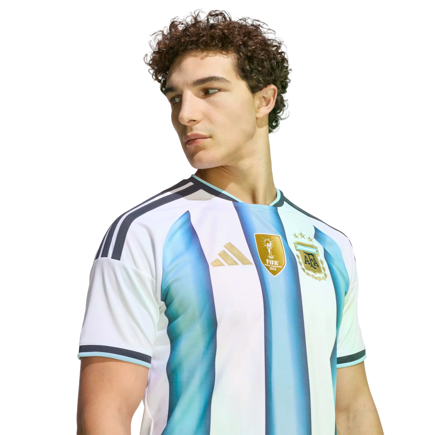A young man with curly hair wearing an Argentina national team soccer jersey, looking to the side against a solid black background.