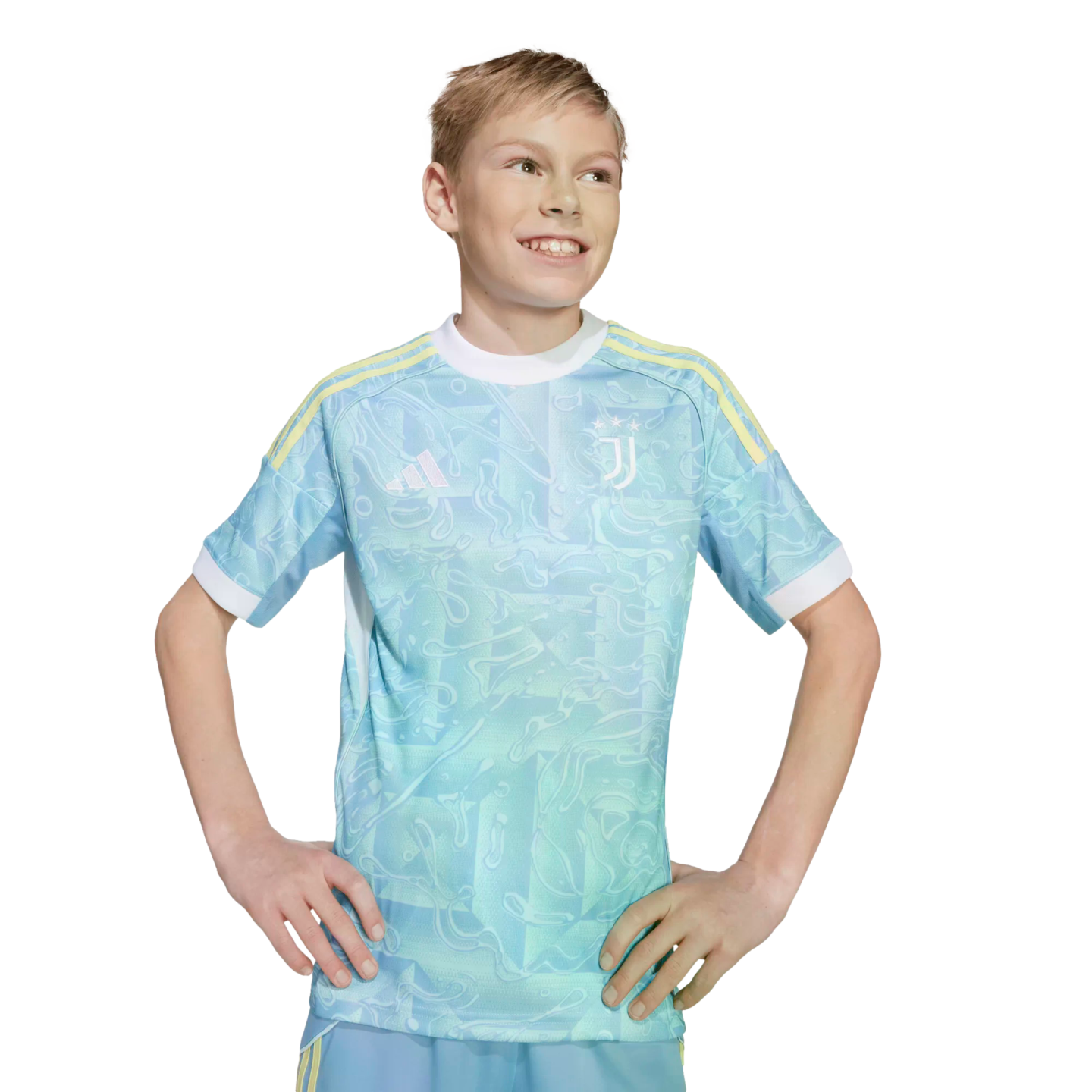 Smiling blonde boy in a light blue patterned Juventus soccer jersey with yellow shoulder stripes, posing with hands on hips against a white background.