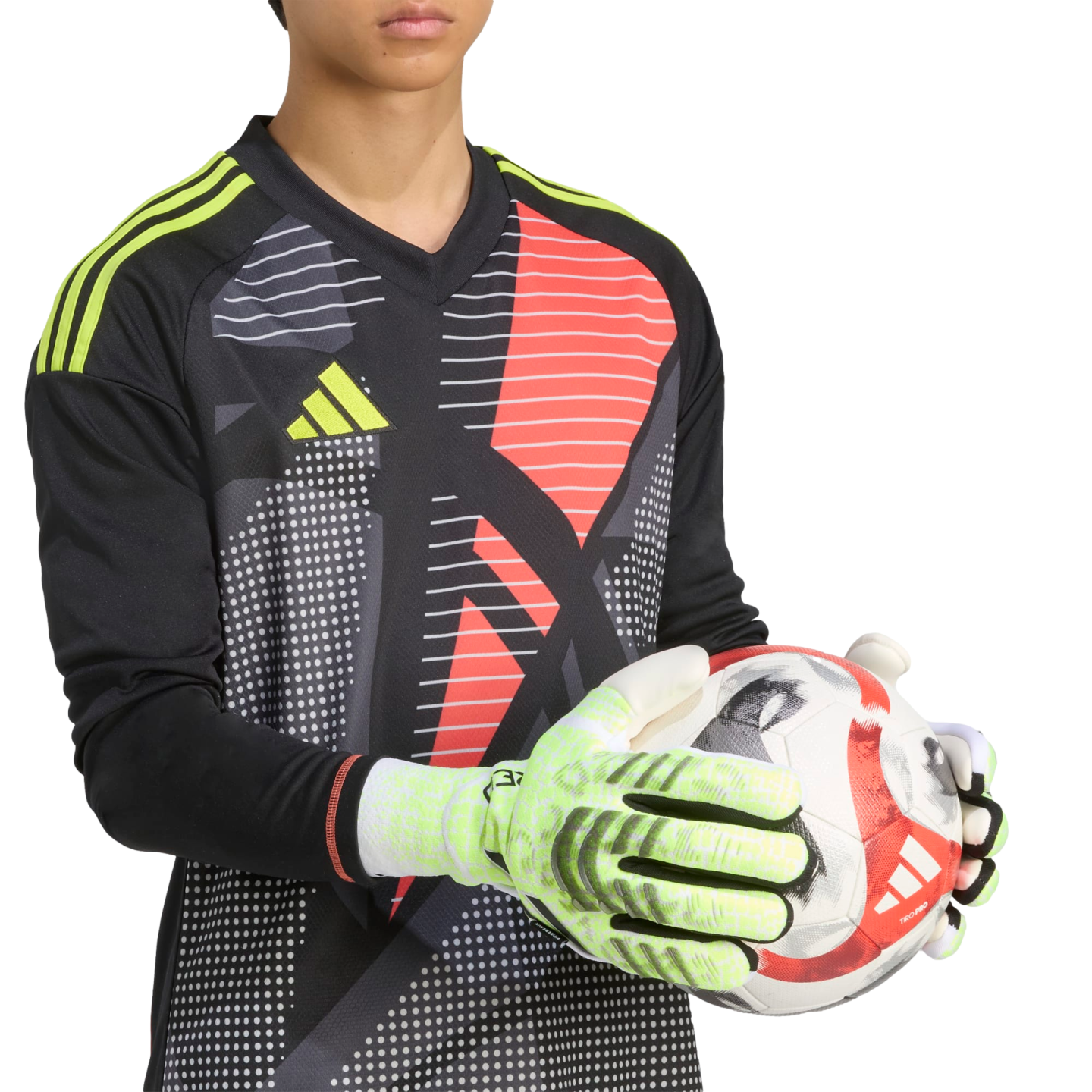 Goalkeeper in a black and red patterned Adidas jersey holds a soccer ball with lime green gloves against a black background.