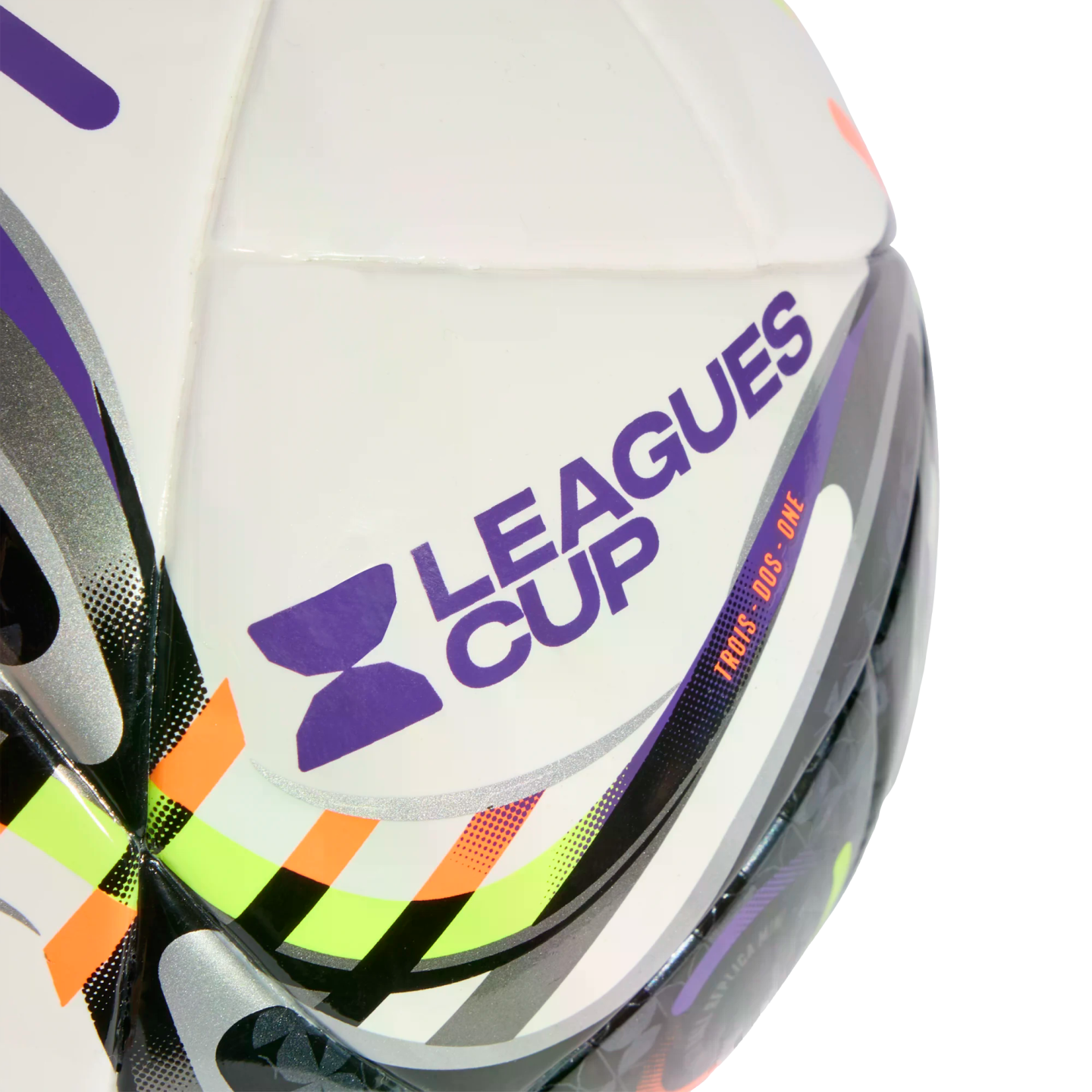 Close-up of a white soccer ball featuring the purple Leagues Cup logo and vibrant orange, lime green, and black patterns.