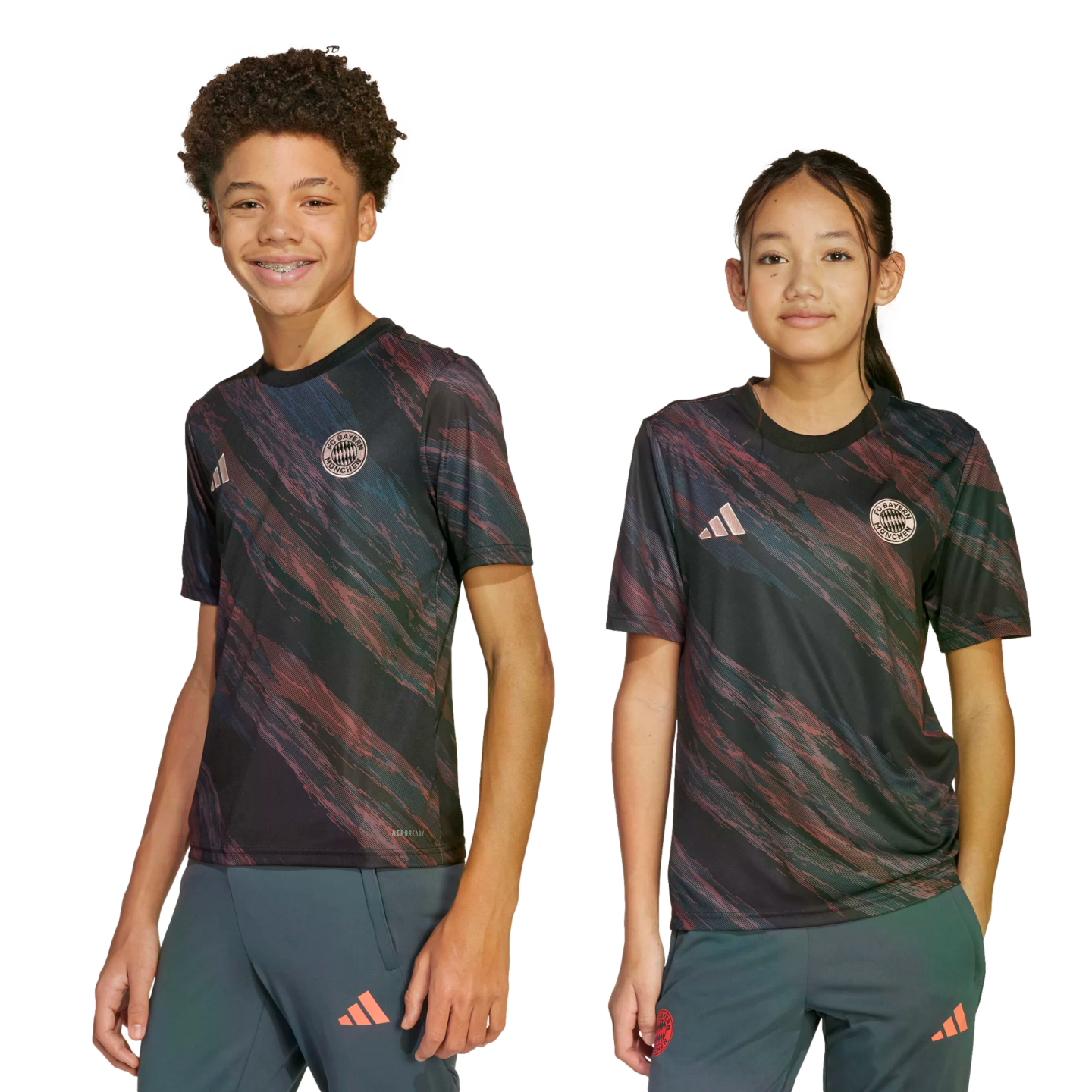 A boy and a girl pose in matching black FC Bayern Munich soccer jerseys with a pink and green swirled pattern, standing against a white background.