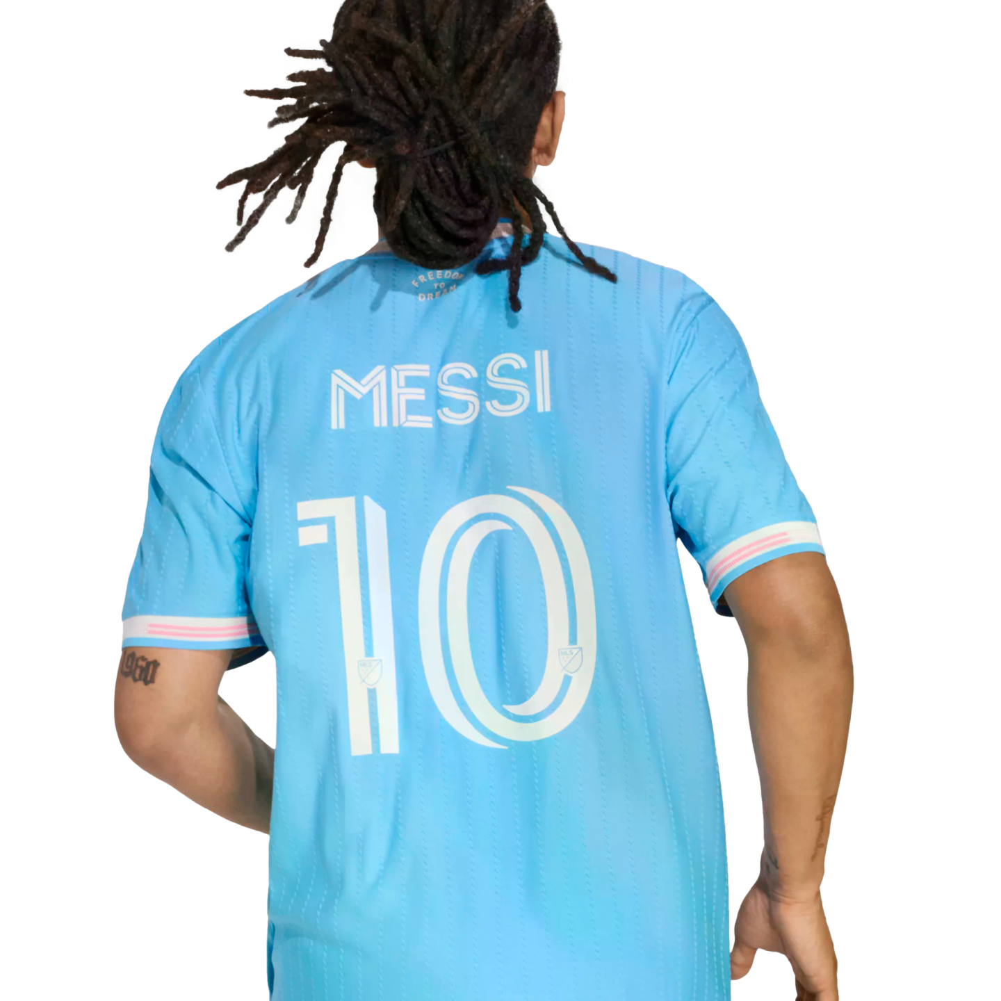 Back view of a person with dreadlocks wearing a light blue soccer jersey with the name 'MESSI' and number '10' printed on the back.