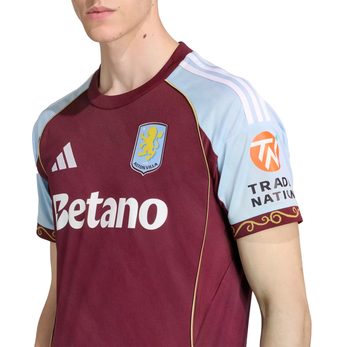Close-up of a person wearing an Aston Villa home football jersey, featuring a maroon body, light blue sleeves, and the Betano sponsor logo.
