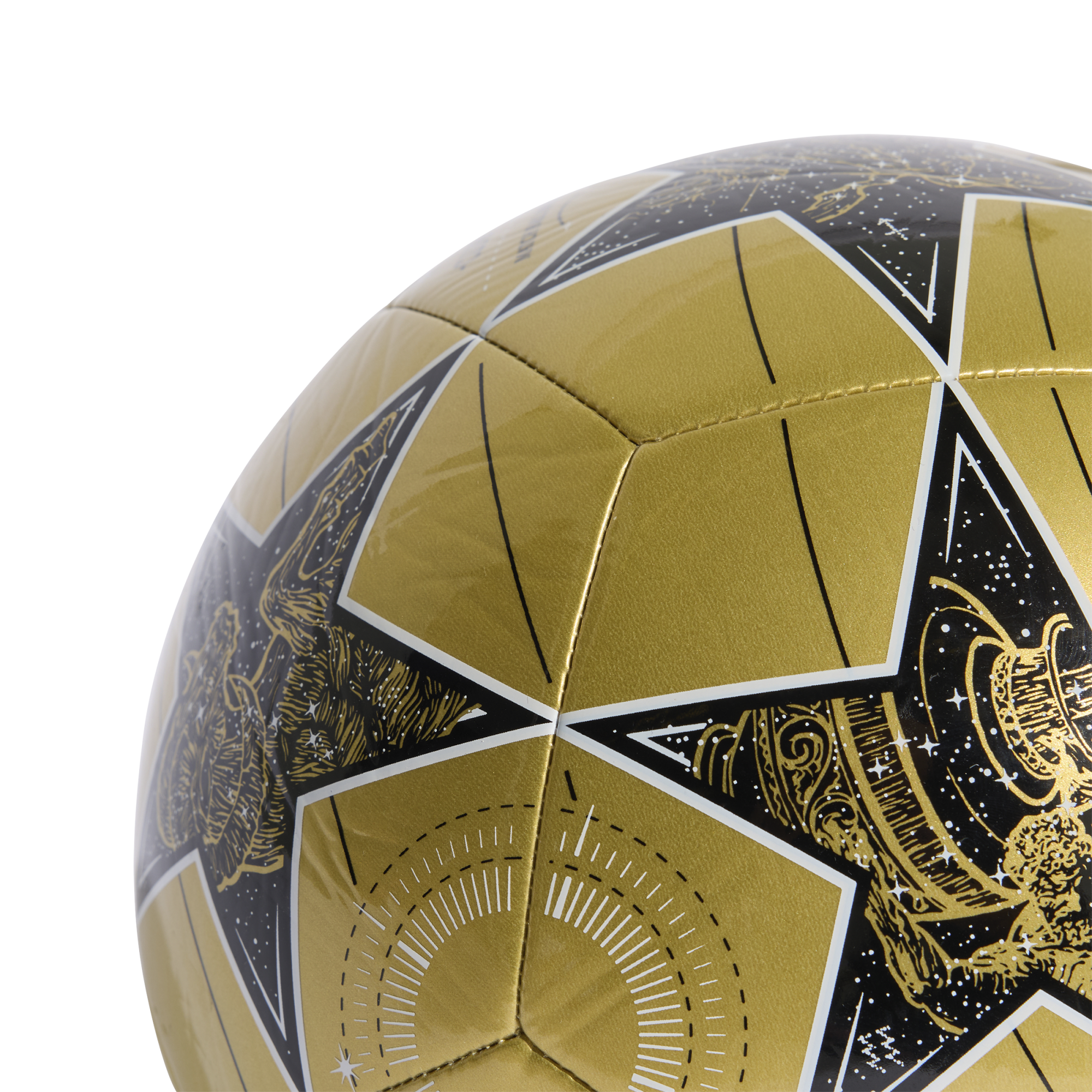 Close-up of a gold UEFA Champions League soccer ball with black star panels featuring detailed celestial artwork.