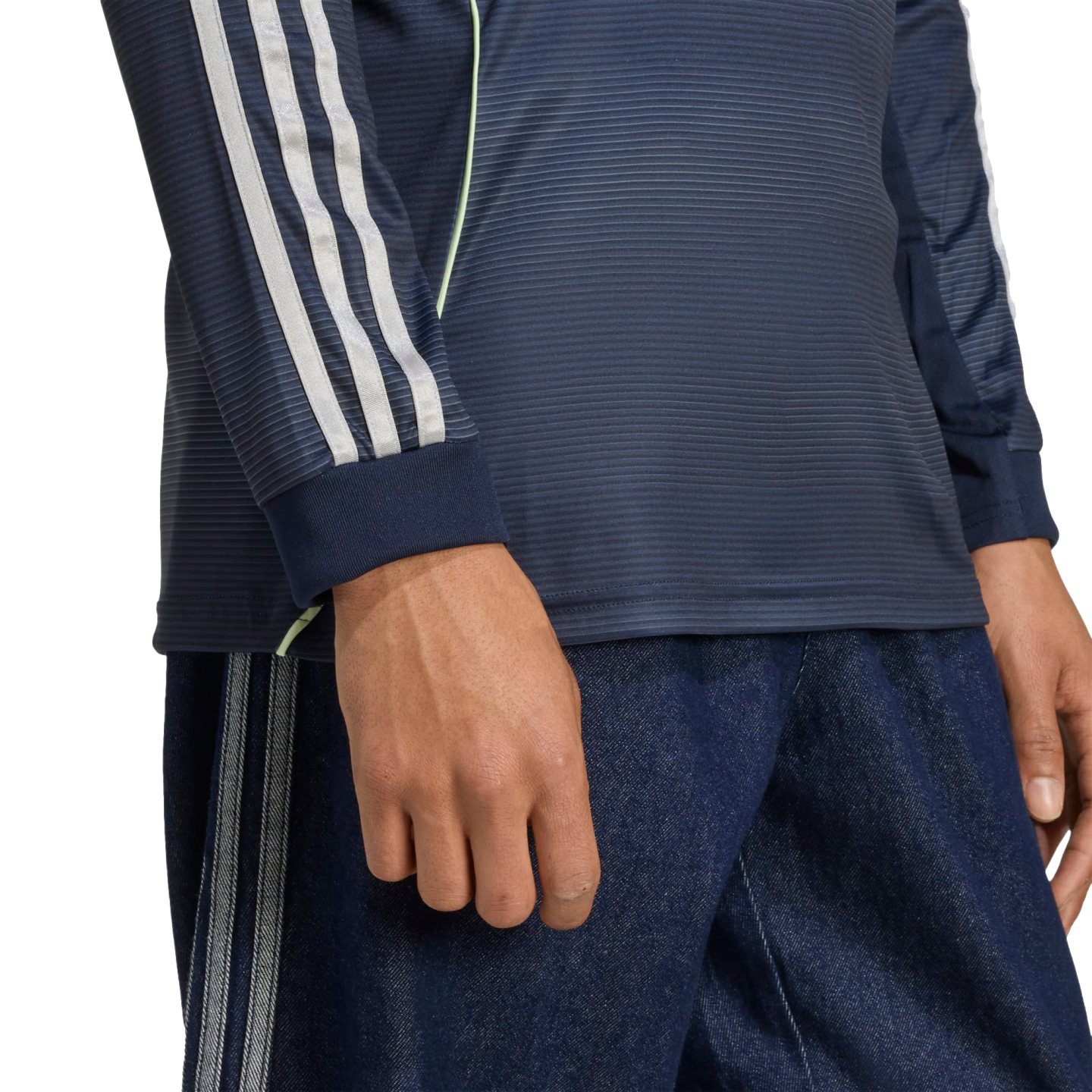 Close-up of a person wearing a navy long-sleeve shirt with light blue stripes and matching dark blue pants against a white background.