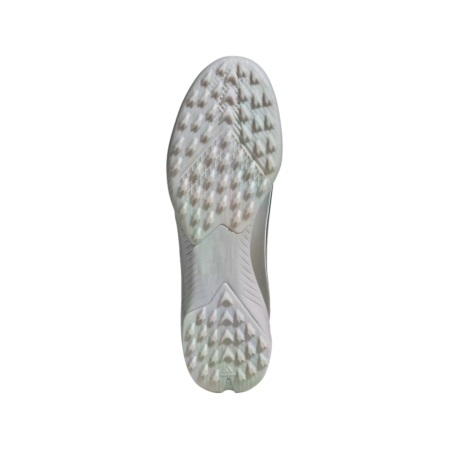 Underside of a silver Adidas turf soccer shoe showing a translucent, multi-studded outsole and brand logo at the heel, isolated on a white background.