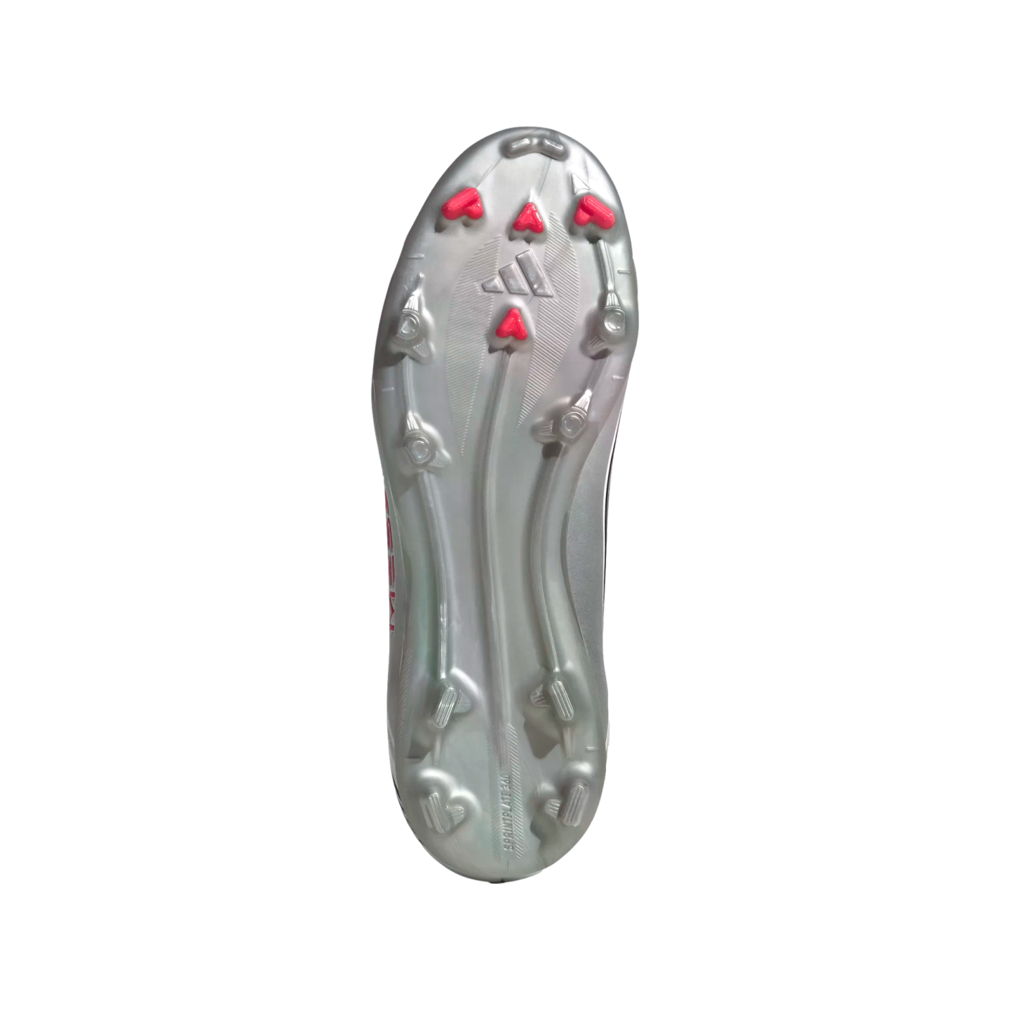 The metallic silver outsole of a soccer cleat with silver and bright pink chevron studs against a white background.