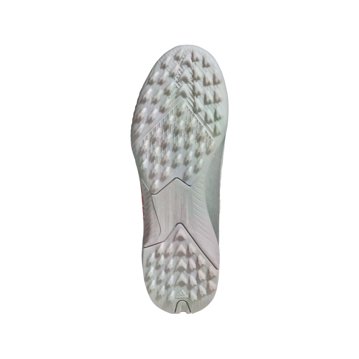 Underside of a light-colored Adidas soccer turf shoe, featuring a rubber outsole with numerous small triangular traction studs.