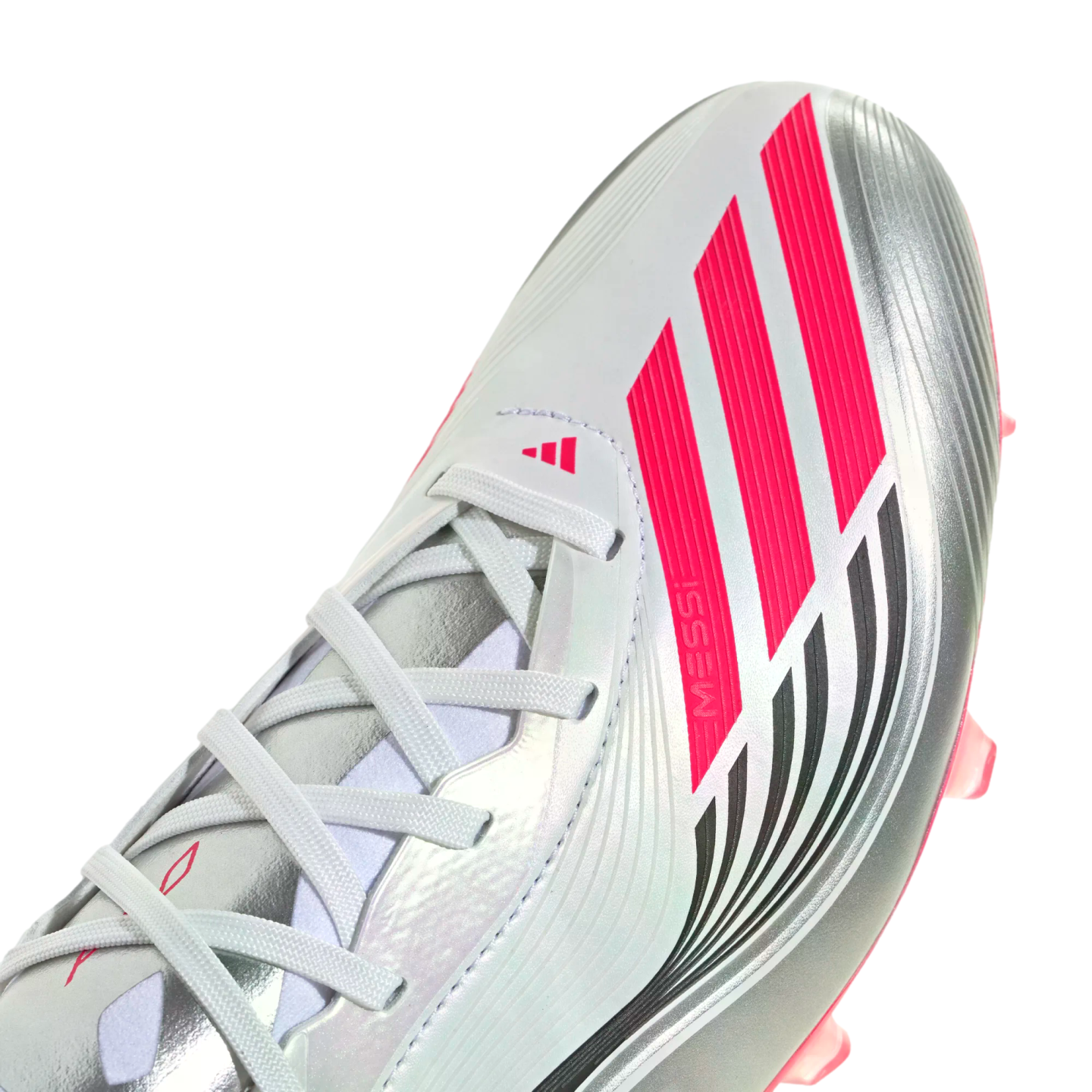 Close-up of a silver Adidas soccer cleat featuring vibrant pink stripes, "MESSI" branding, and white laces.