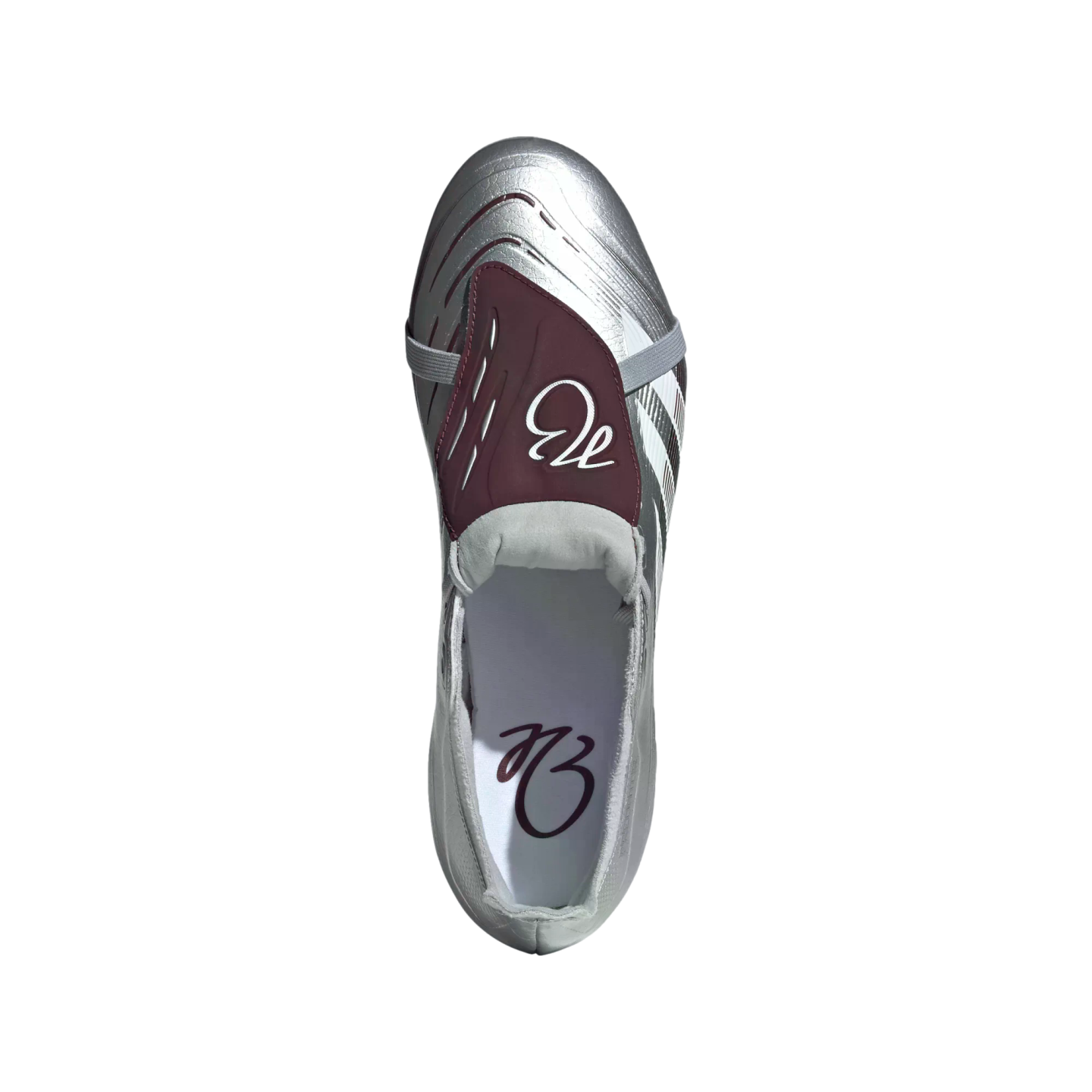 Top-down view of a silver metallic soccer cleat with a maroon fold-over tongue featuring a white script logo.