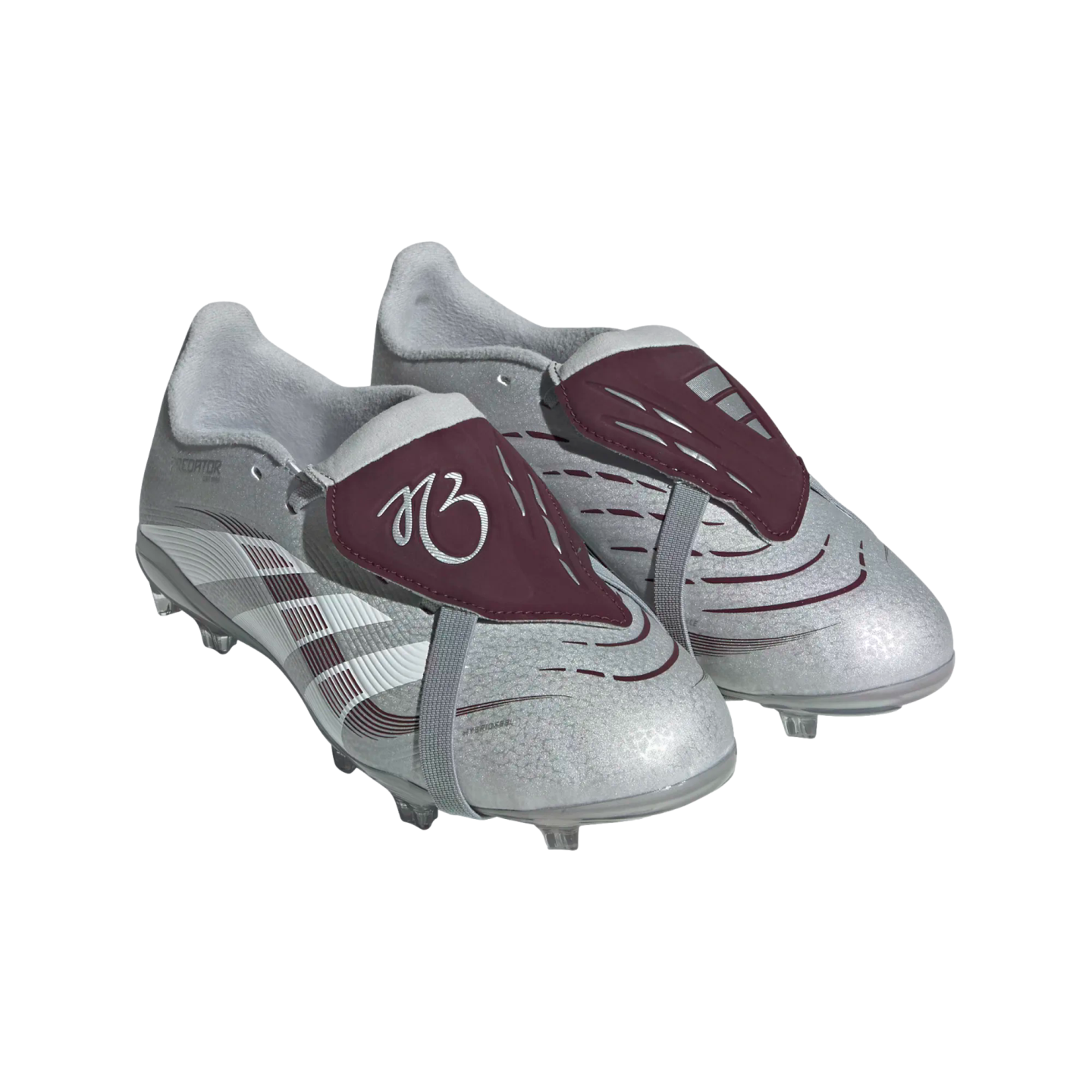 Silver sparkly soccer cleats with maroon fold-over tongues and grey straps on a white background.
