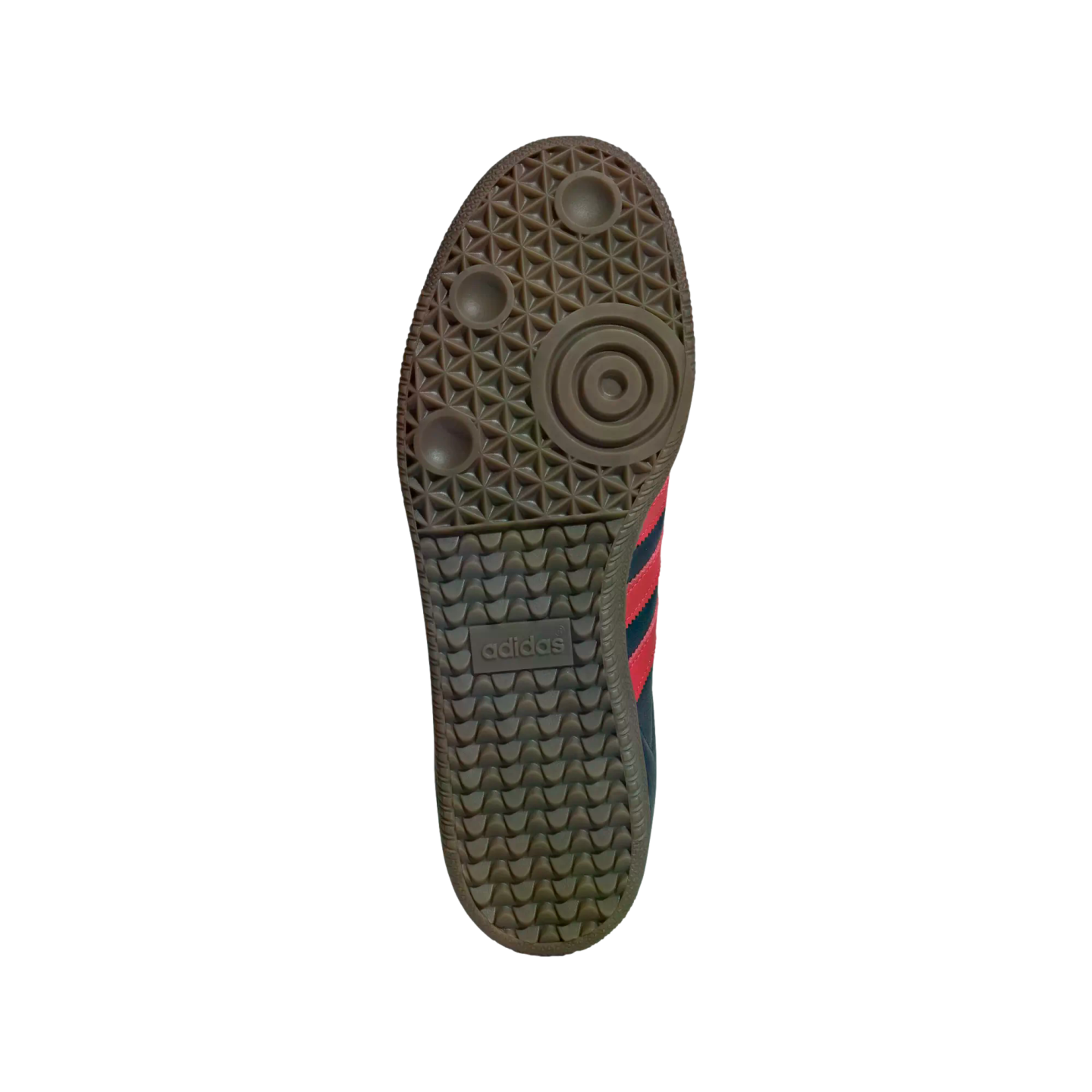 Underside of a brown gum rubber Adidas sneaker sole with traction patterns and a centered logo, shown against a solid black background.