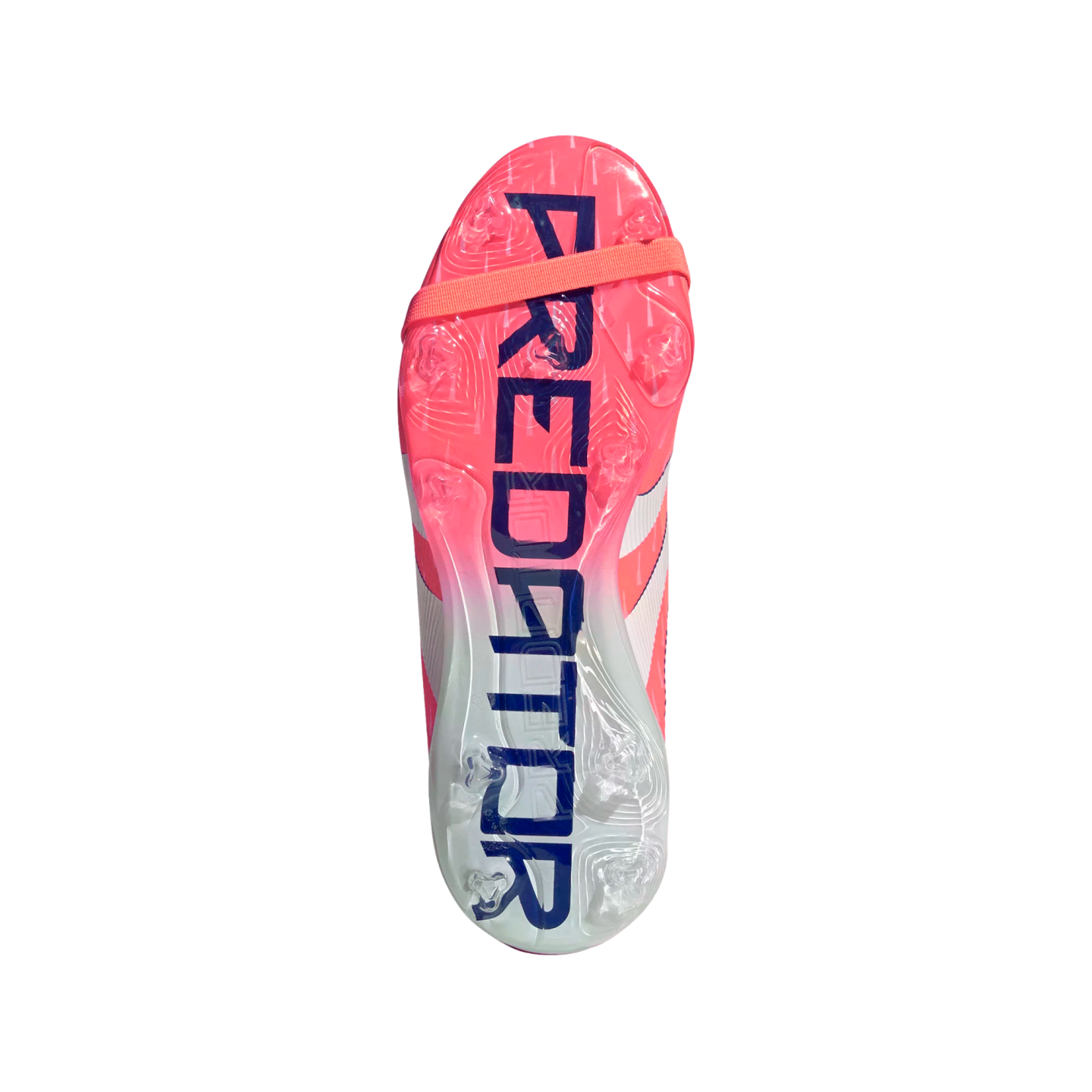 Bottom of a pink and white Adidas Predator soccer cleat with "PREDATOR" in large blue letters across the sole, transparent studs, and an elastic strap near the toe.