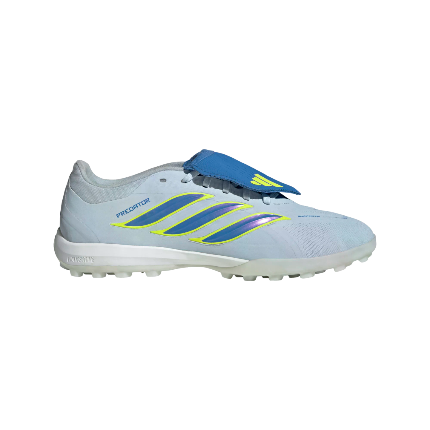 A side profile of a light blue Adidas Predator turf soccer shoe on a black background. The shoe features three iridescent blue and purple stripes with neon yellow outlines along the side. It has a royal blue fold-over tongue, a white midsole, and a transl