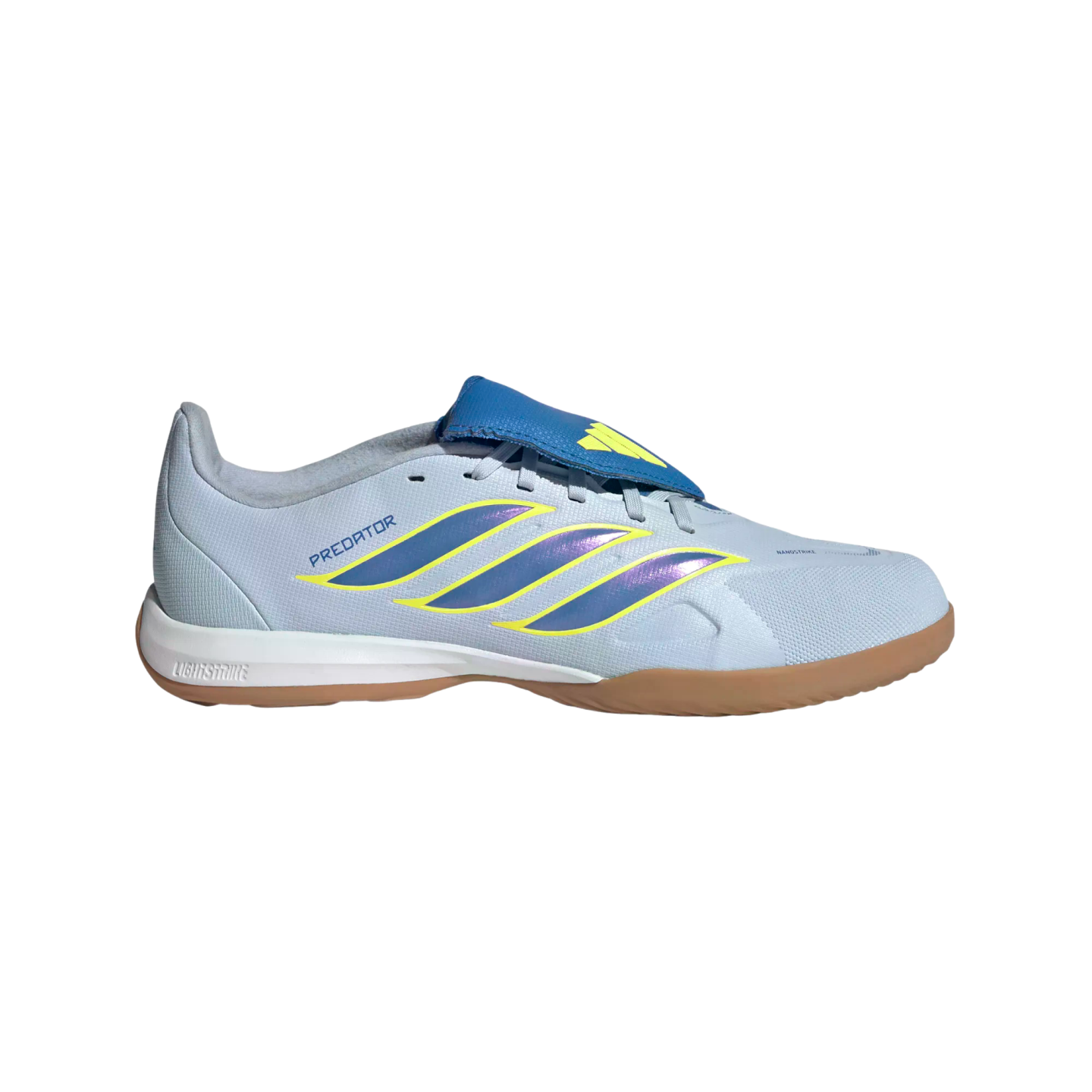 A side profile of a light blue Adidas Predator indoor soccer shoe featuring iridescent purple and yellow stripes, a blue fold-over tongue, and a gum-colored outsole against a black background.