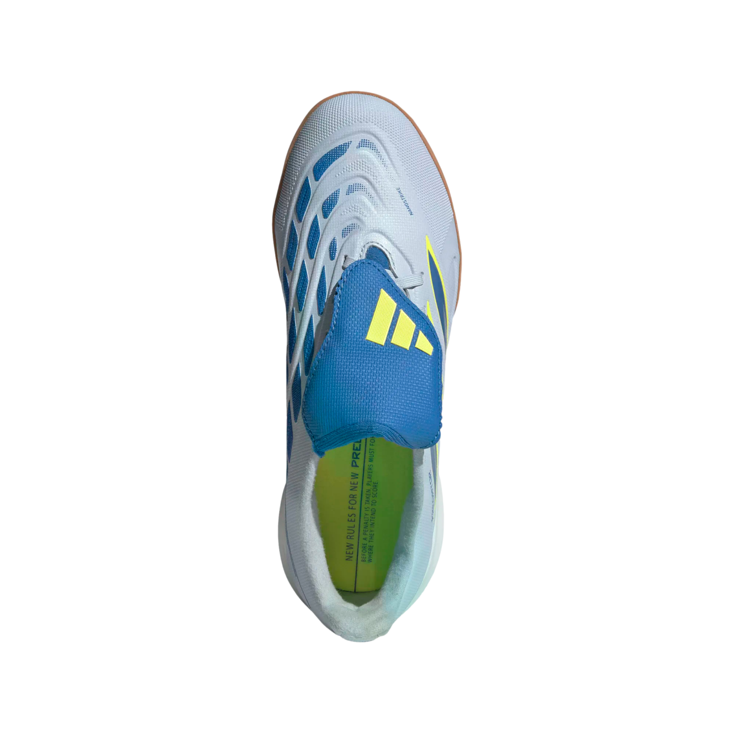 A top-down view of a light gray Adidas Predator indoor soccer shoe featuring a blue tongue cover with yellow stripes, blue textured accents, and a lime green insole against a black background.