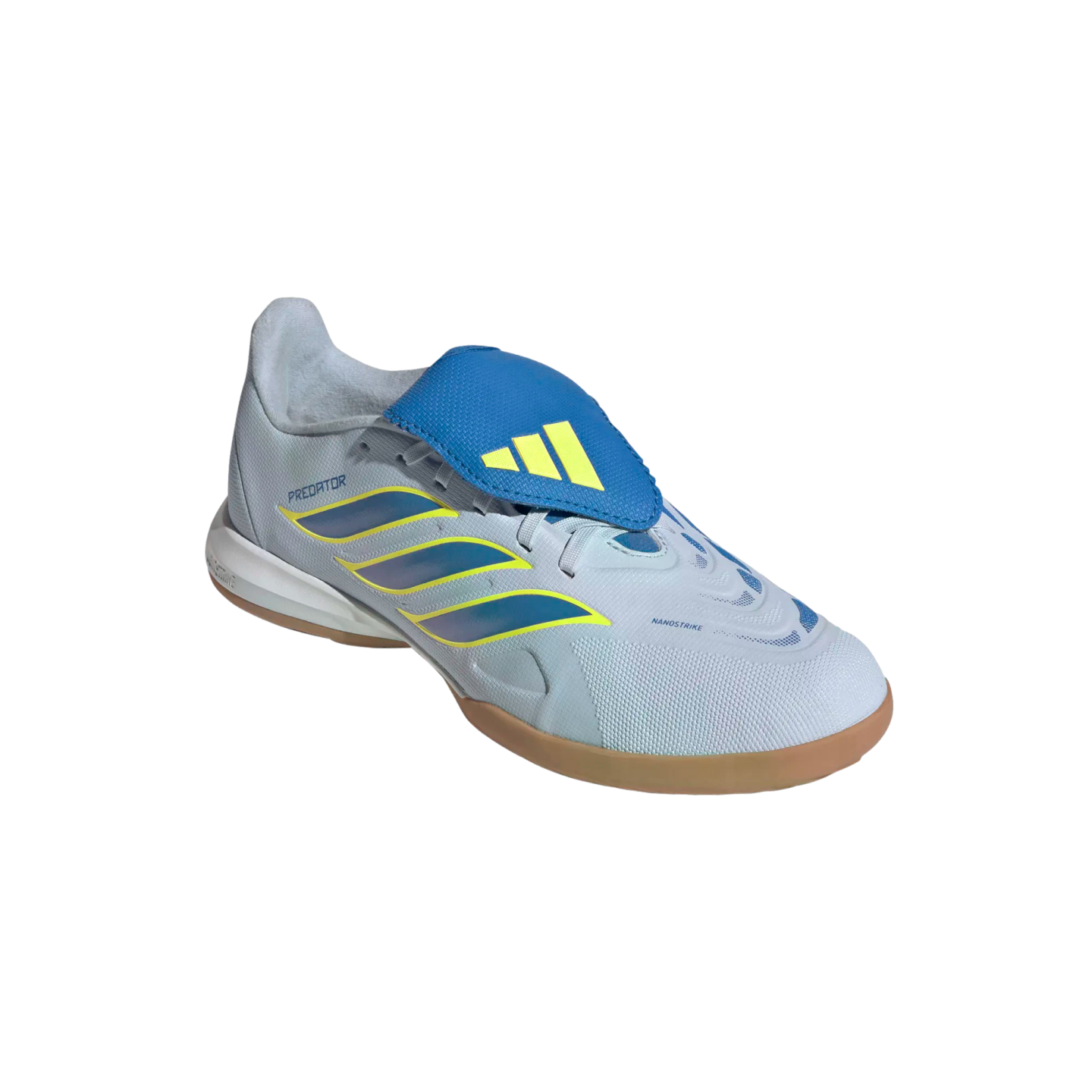 A side-angle view of an Adidas Predator indoor soccer shoe against a black background. The shoe features a light grey textured upper with three iridescent blue stripes outlined in yellow, a prominent blue fold-over tongue with a yellow Adidas logo, and a