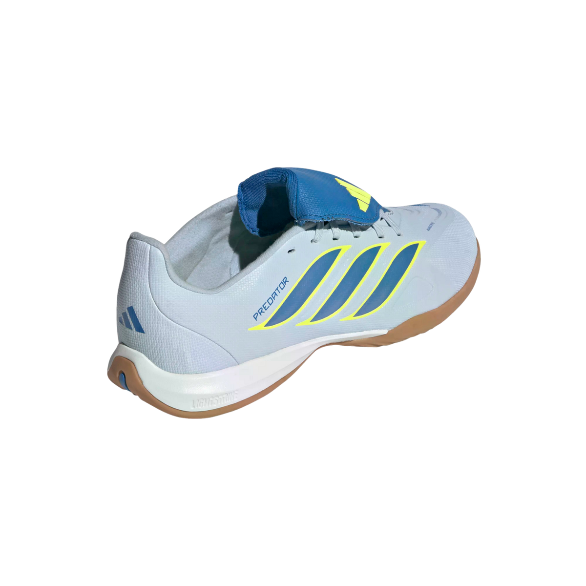 A rear three-quarter view of a light blue Adidas Predator indoor soccer shoe against a black background. The shoe features three diagonal dark blue stripes outlined in yellow on the side and the word "PREDATOR" in blue. It has a prominent blue fold-over t