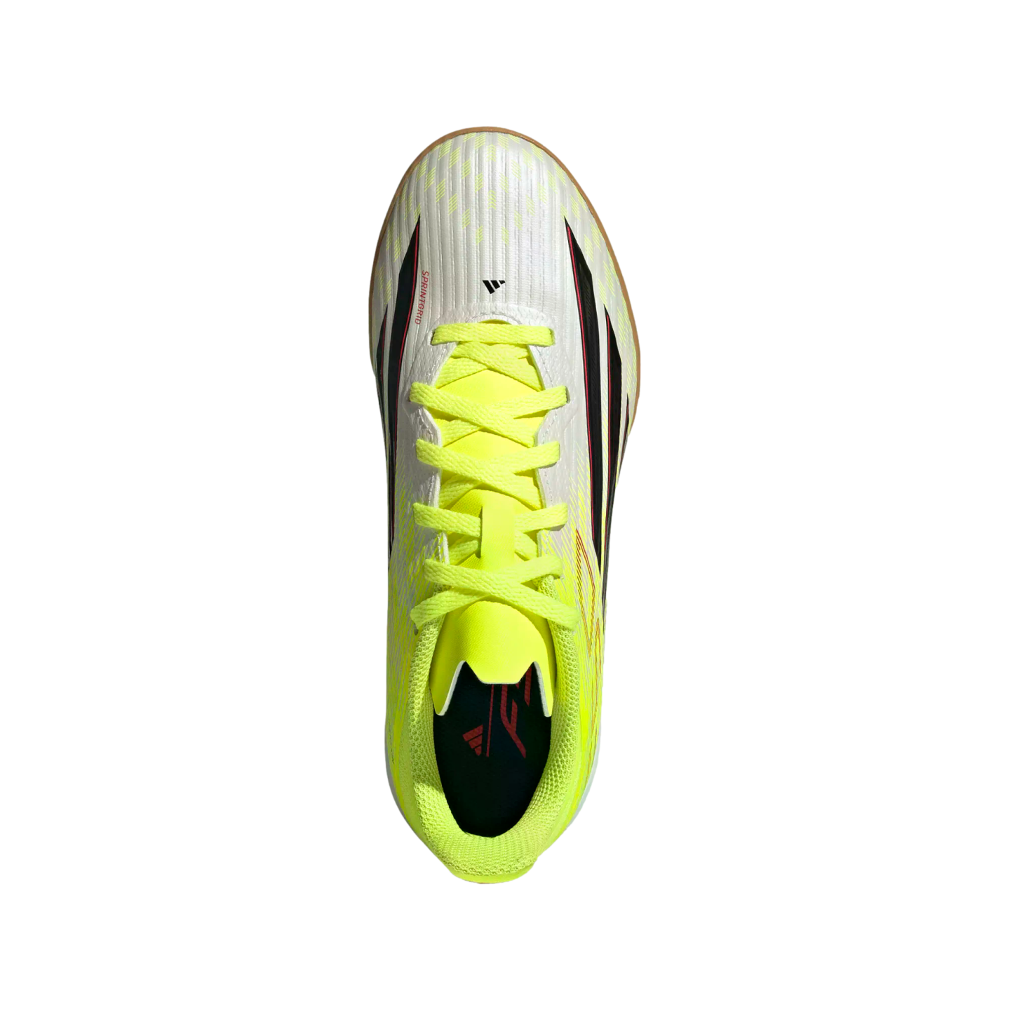 Top-down view of a white Adidas indoor soccer shoe with neon yellow laces and collar, featuring black and red accents on a solid black background.
