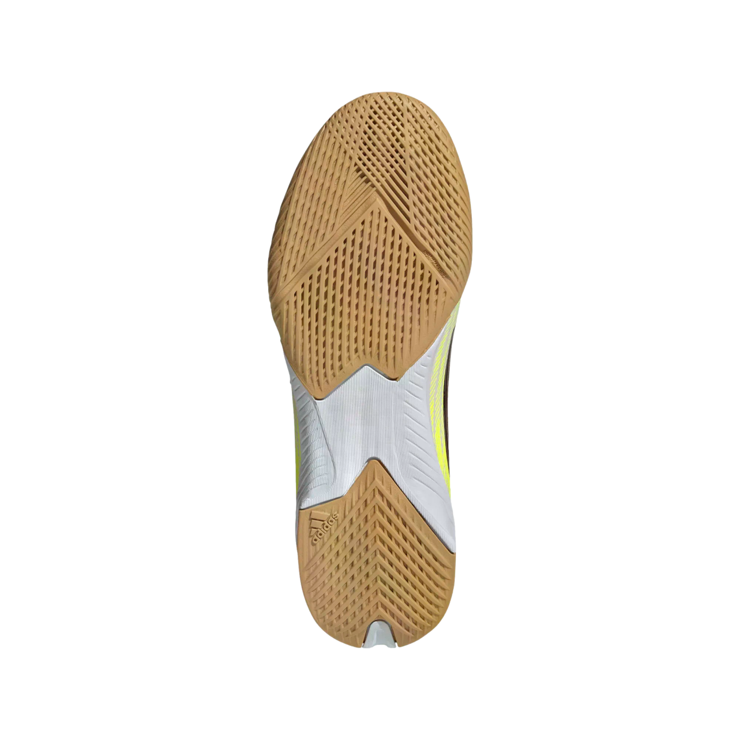 Bottom view of a tan and white Adidas athletic shoe sole with textured gum rubber tread on a black background.