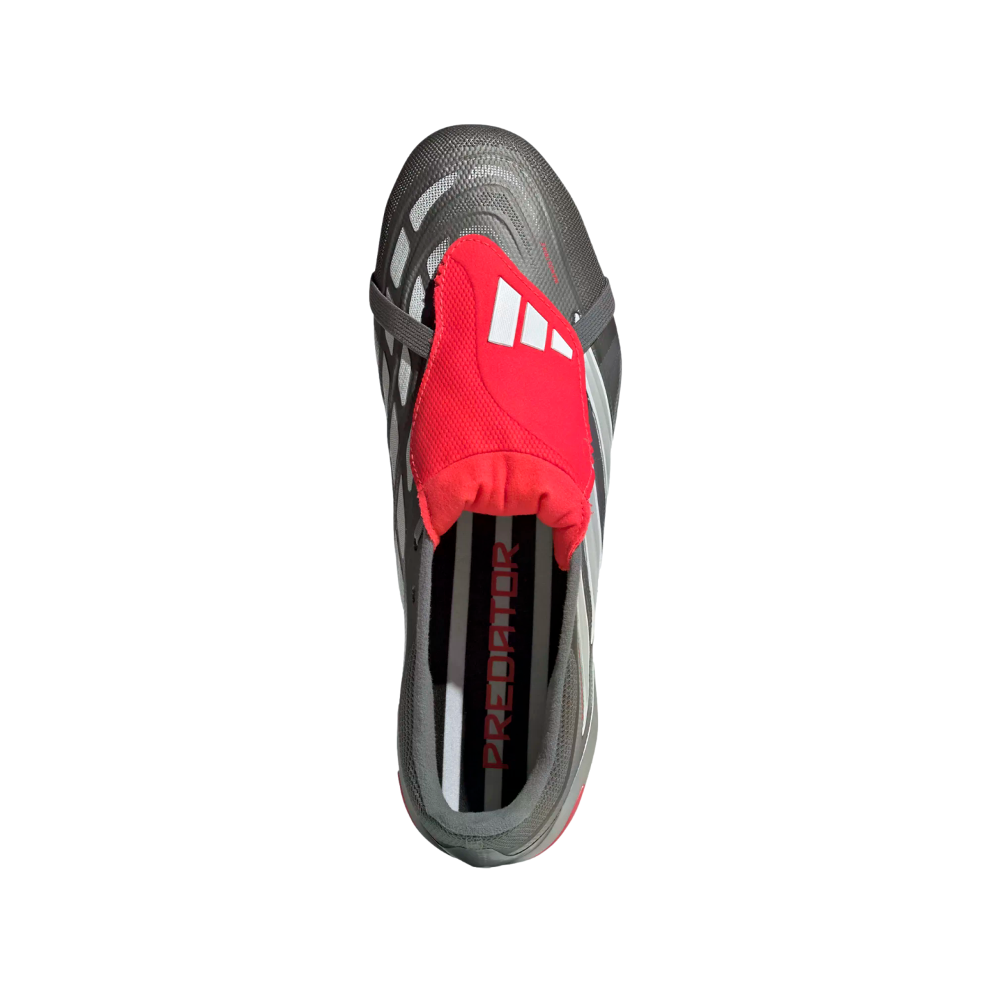 Top-down view of a grey Adidas Predator soccer cleat featuring a prominent red fold-over tongue with white stripes, set against a black background.