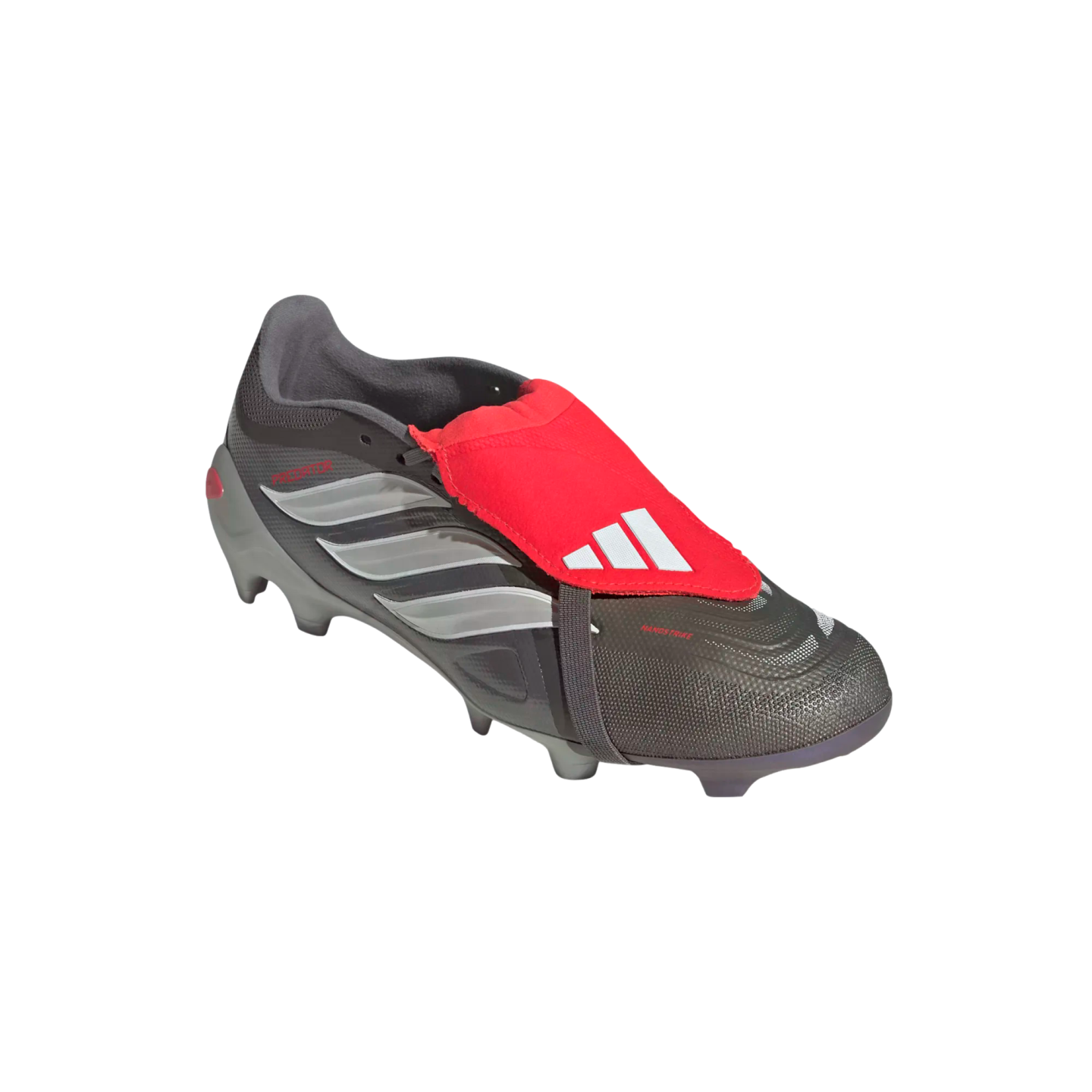 Grey and silver Adidas Predator soccer boot featuring a prominent red fold-over tongue with white logo, isolated on a black background.