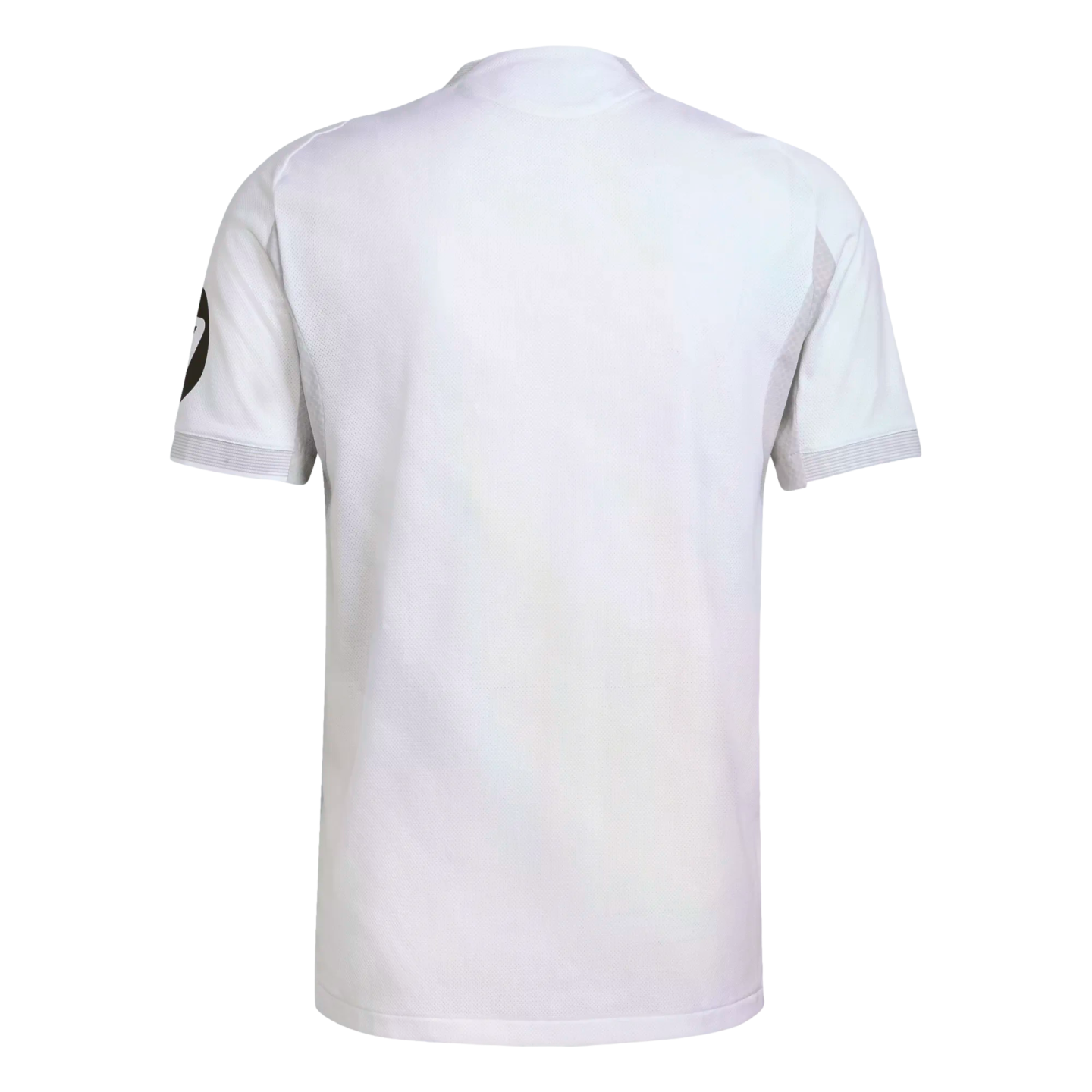Back view of a white short-sleeved sports shirt with a subtle textured mesh and a black circular logo on the left sleeve, isolated on a white background.