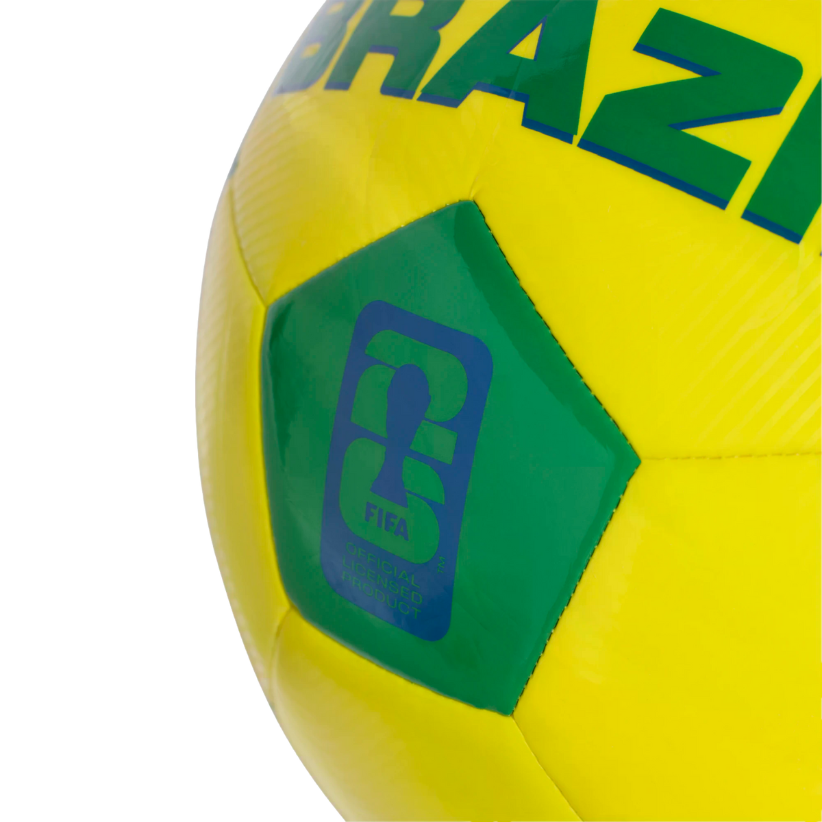 A close-up of a yellow and green soccer ball featuring the word "BRAZIL" and a blue FIFA "Official Licensed Product" logo with a World Cup trophy silhouette on a green pentagonal panel.