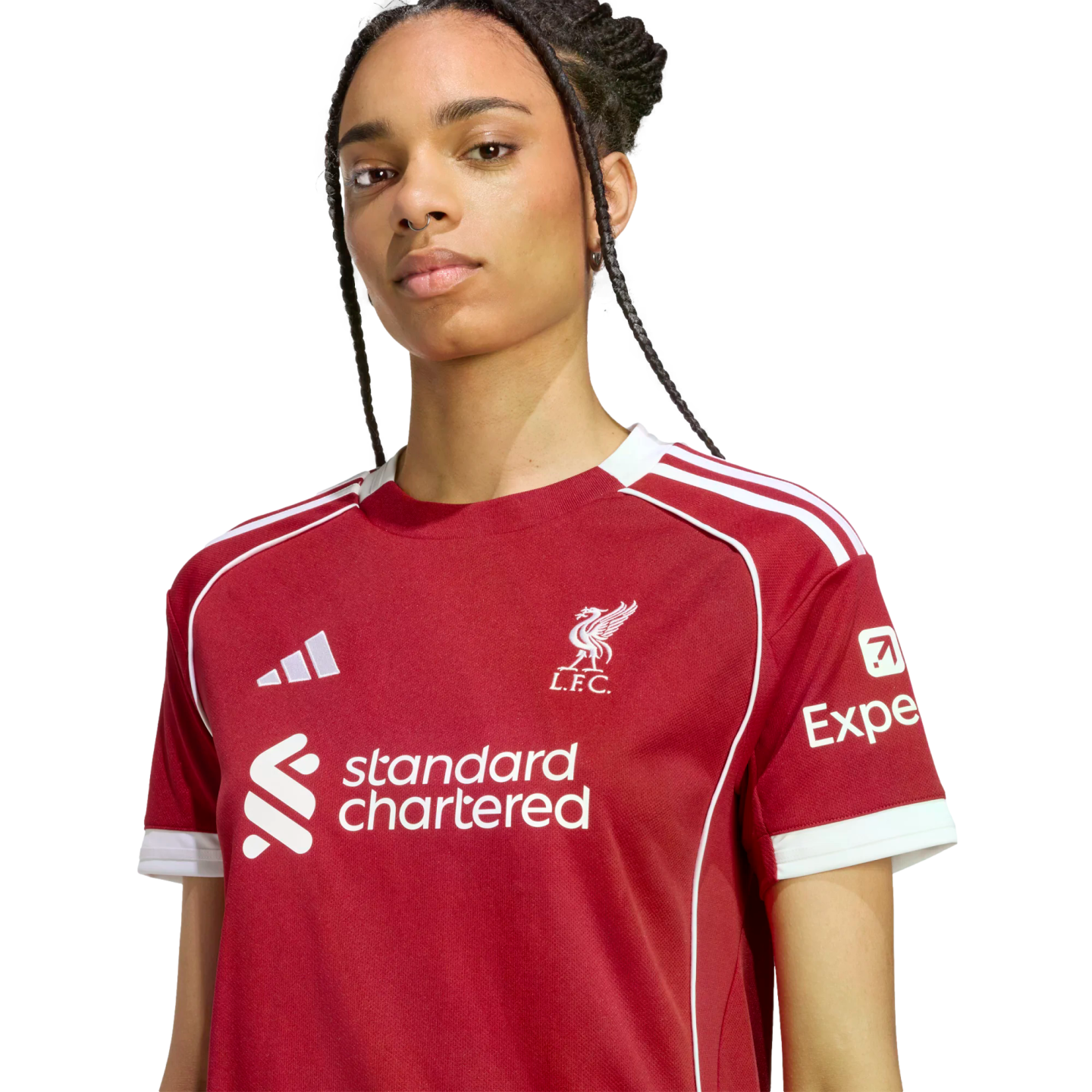A woman wearing a red Liverpool F.C. football jersey with white trim and sponsor logos, facing forward against a black background.
