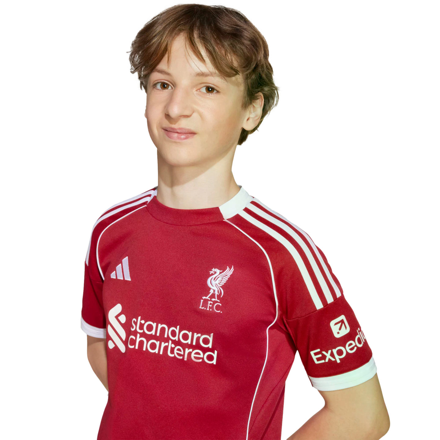 Young person with wavy brown hair wearing a red Liverpool F.C. jersey against a black background.