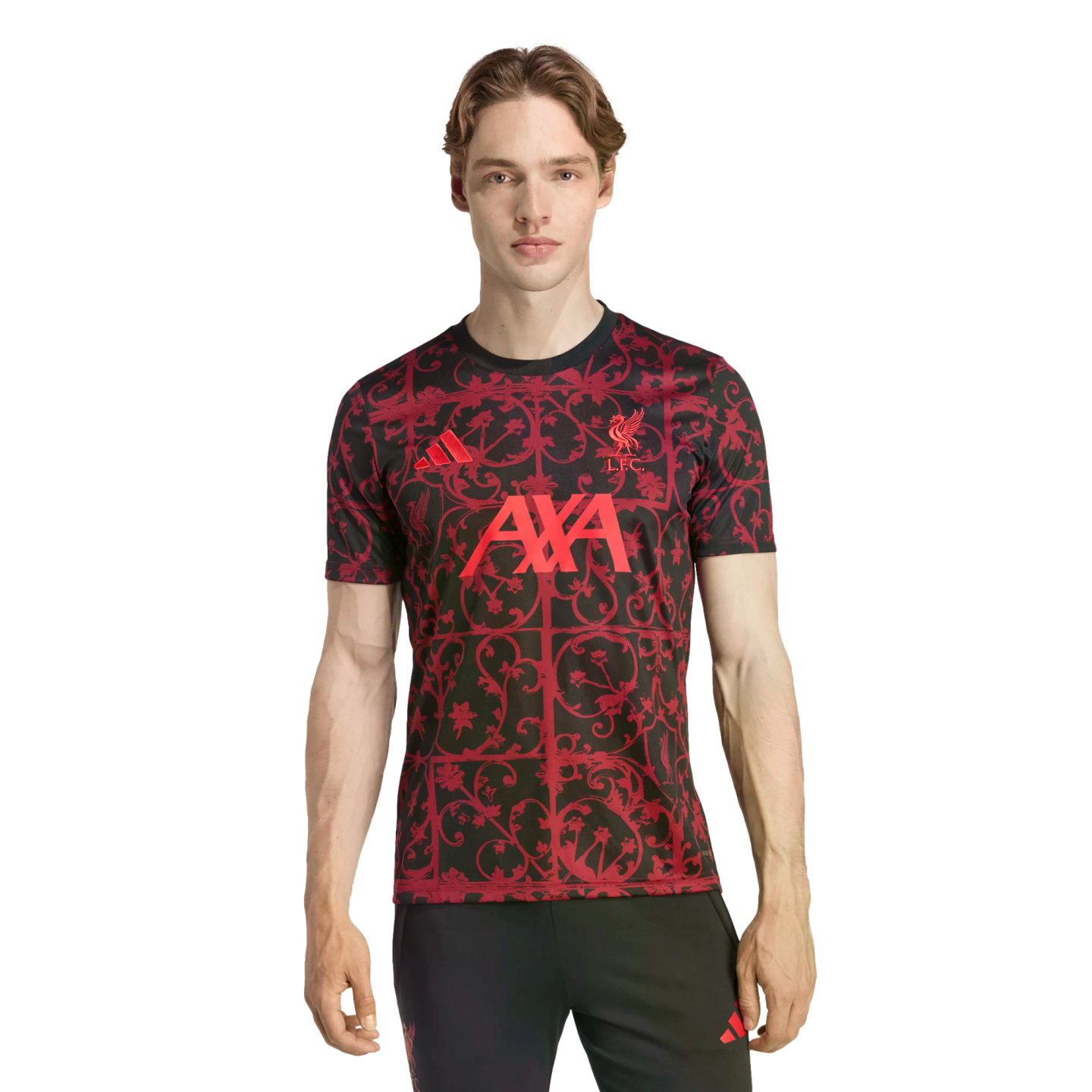 A man wearing a black and red patterned Adidas Liverpool F.C. training jersey with AXA sponsor logo, against a black background.