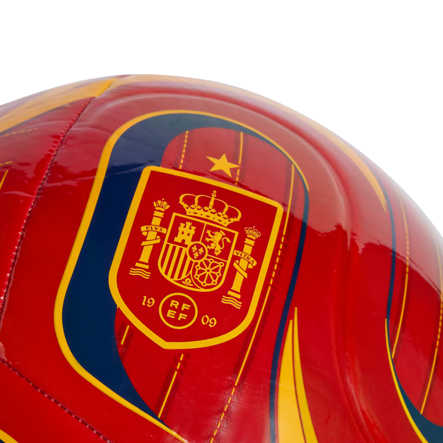 Close-up of a glossy red soccer ball featuring the Royal Spanish Football Federation crest in yellow and red, with a single gold star above it.