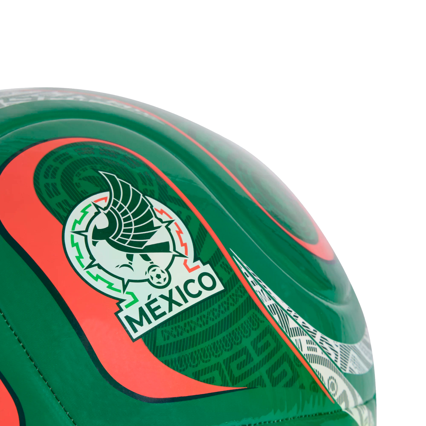 Close-up of a green soccer ball featuring the Mexico national football team crest and intricate red and white patterns.