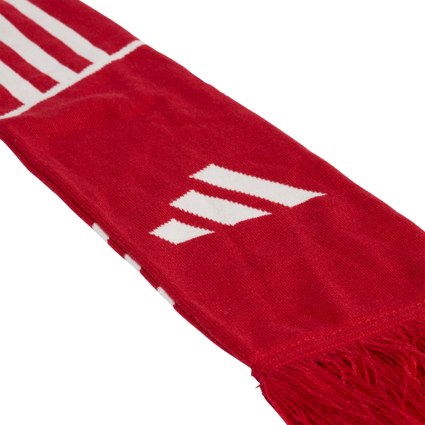 Close-up diagonal shot of a red knitted scarf with white stripes and a three-bar logo, featuring a fringed edge against a solid black background.