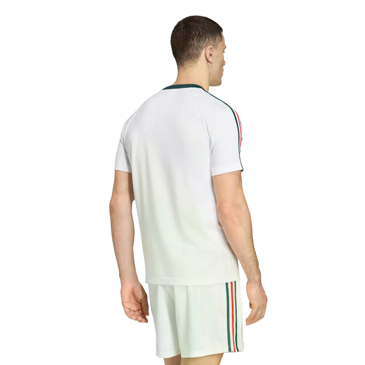 Rear view of a man wearing a white athletic t-shirt and matching shorts set, featuring green, red, and white stripes down the sleeves and sides, set against a black background.