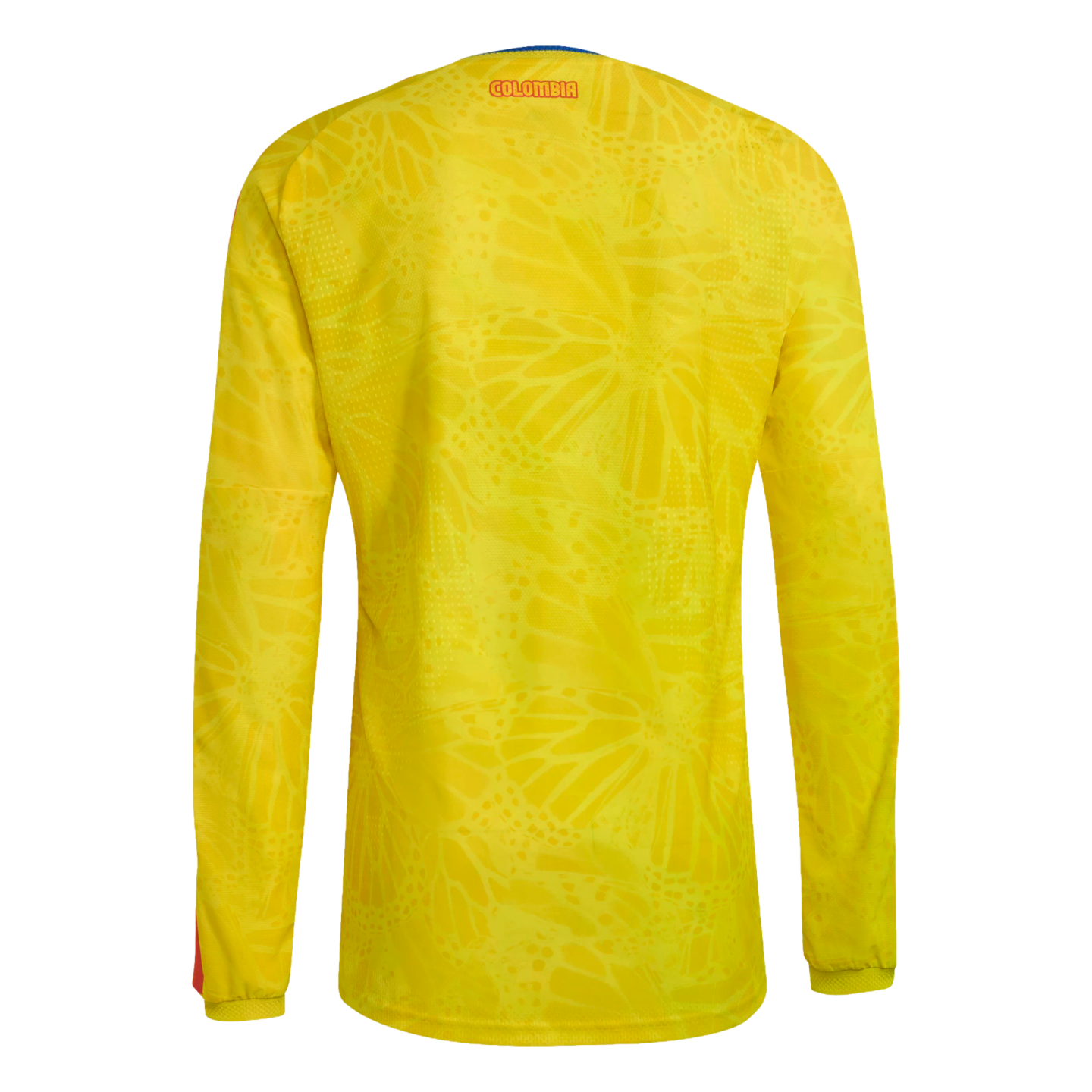 Back view of a yellow long-sleeved Colombia soccer jersey with a subtle butterfly pattern and "COLOMBIA" text on the upper back, shown against a black background.