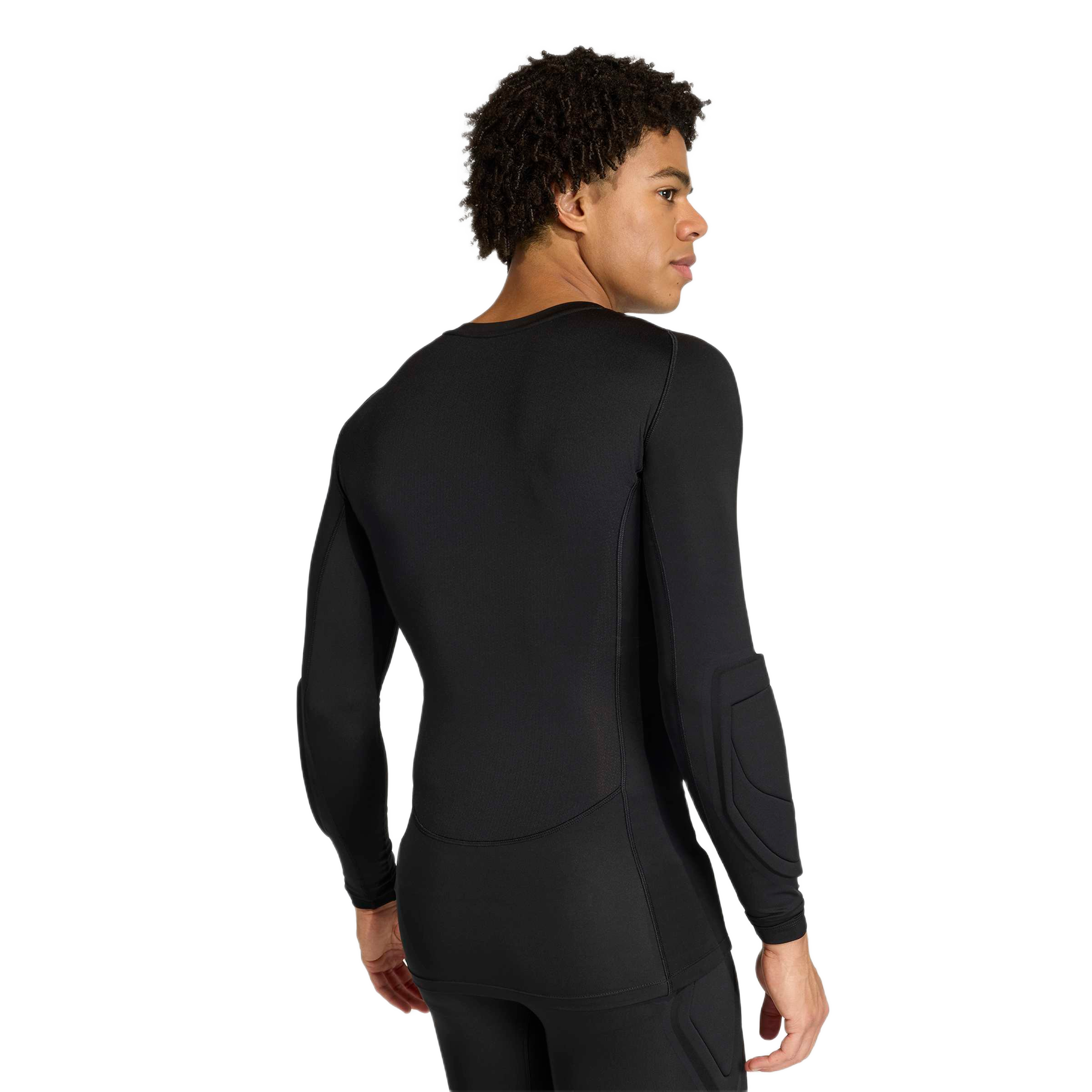 Rear view of a man wearing a black long-sleeved athletic compression shirt with elbow padding and matching black leggings.
