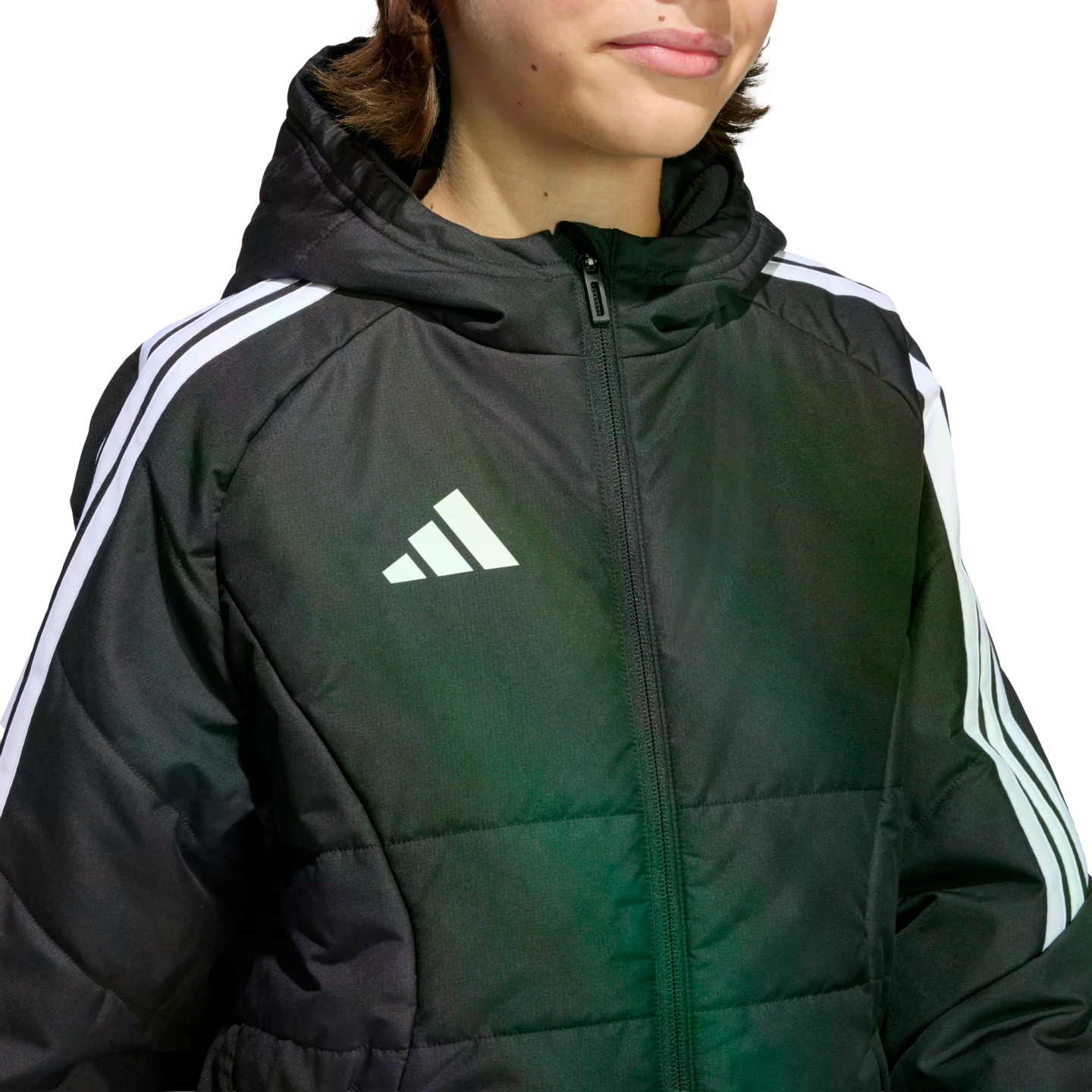 A close-up of a person wearing a black Adidas puffer jacket with white three-stripes on the sleeves and a white logo on the chest.
