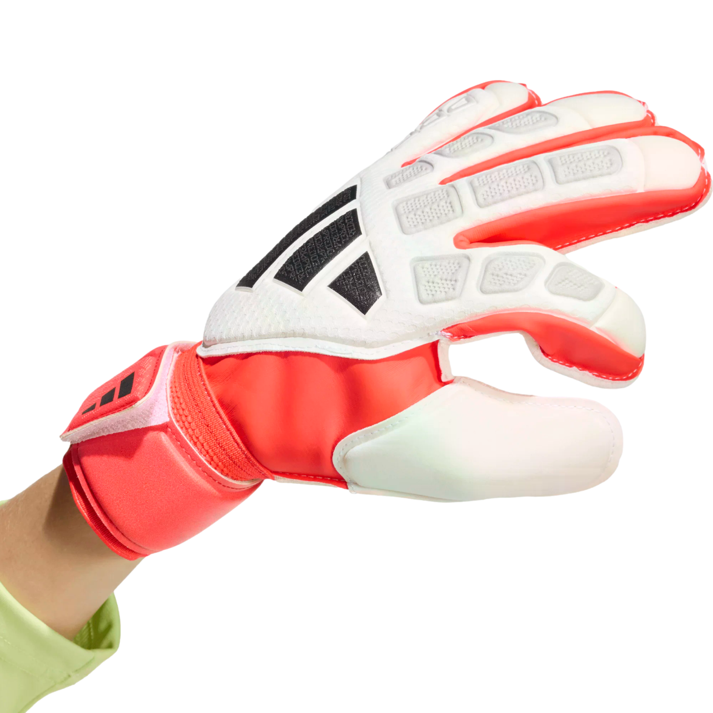 A red and white Adidas goalkeeper glove with black stripes and protective padding, shown against a black background.