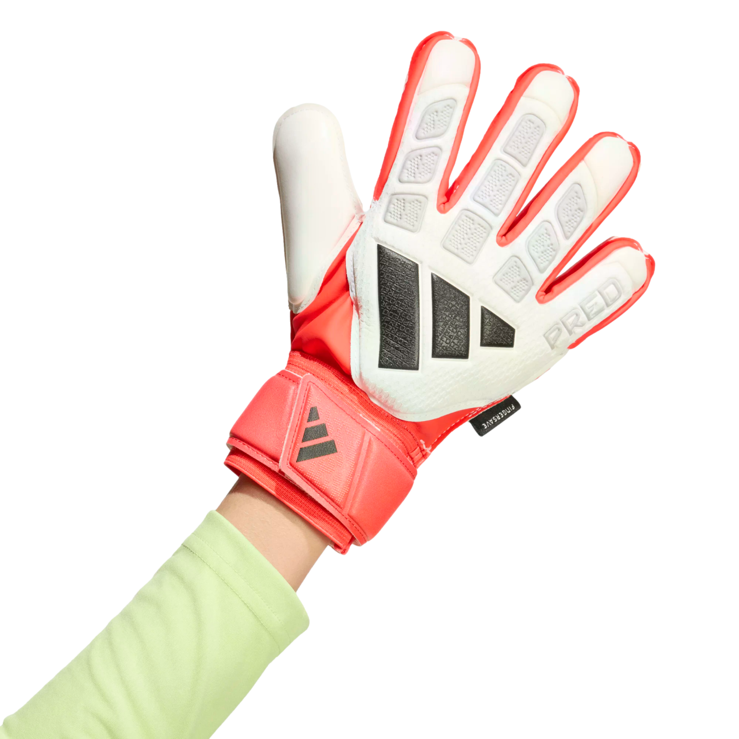 A hand wearing a red and white Adidas Predator goalkeeper glove with black details and a light green long-sleeved shirt against a black background.