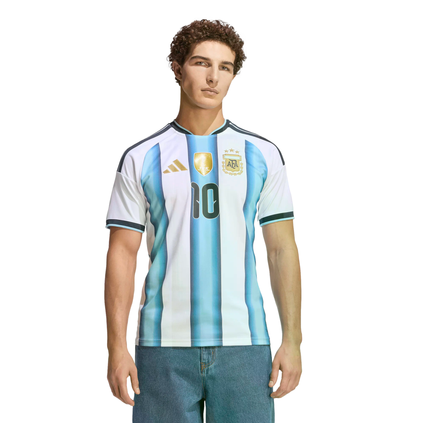 A man with curly hair wearing an Argentina soccer jersey with the number 10 and blue jeans, posed against a black background.
