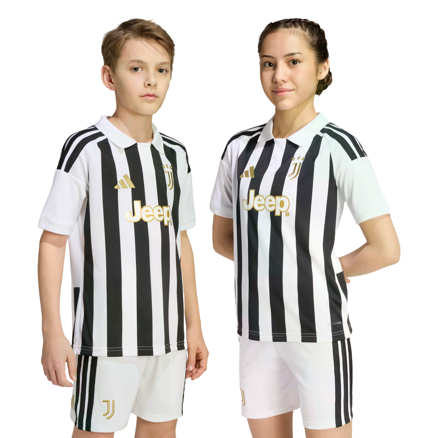Two young people wearing matching black and white striped Juventus football kits with gold logos, standing against a plain white background.