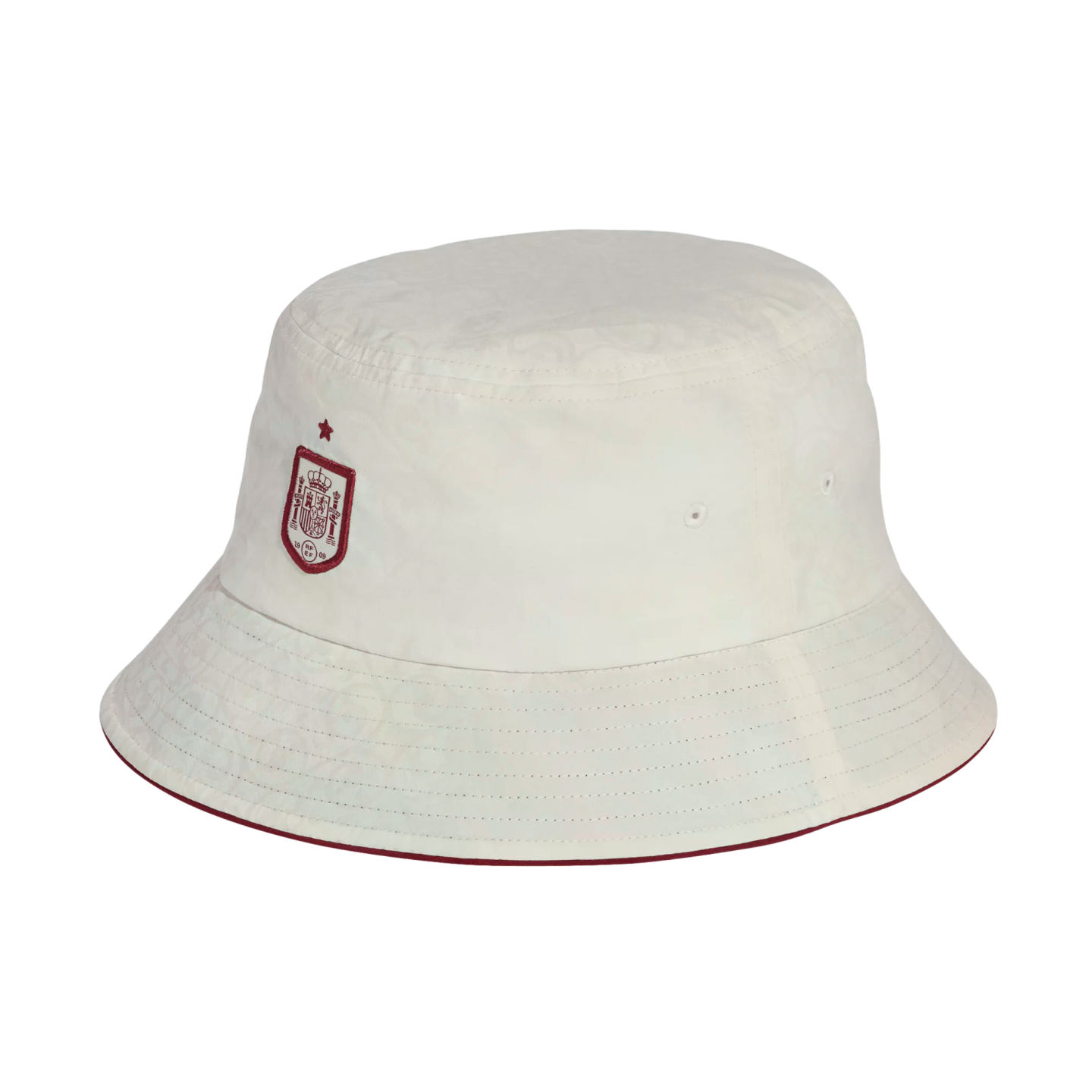 A white bucket hat featuring the red Spain national football team crest and a small star on the front. The brim has a thin red edge.