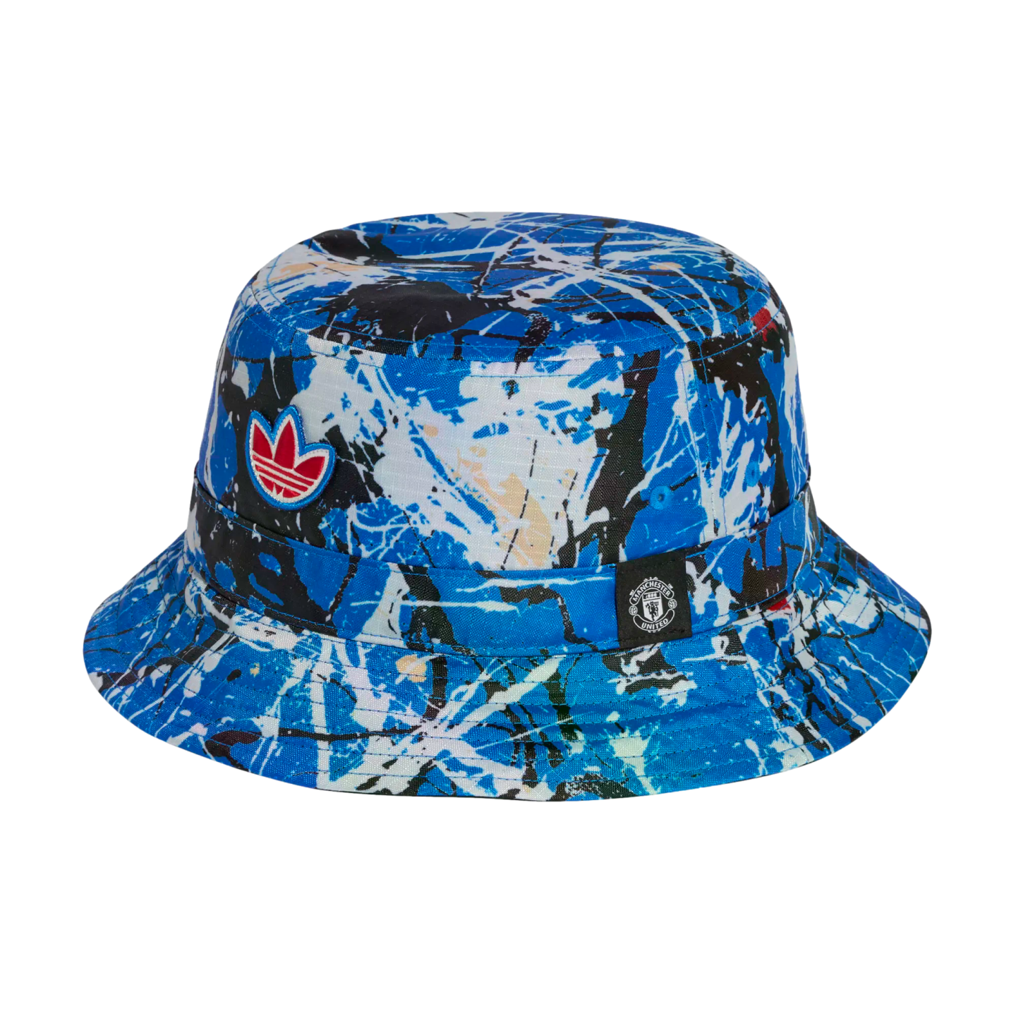 Adidas bucket hat featuring a blue and white paint-splatter design, a red trefoil logo, and a small Manchester United crest tag on a black background.