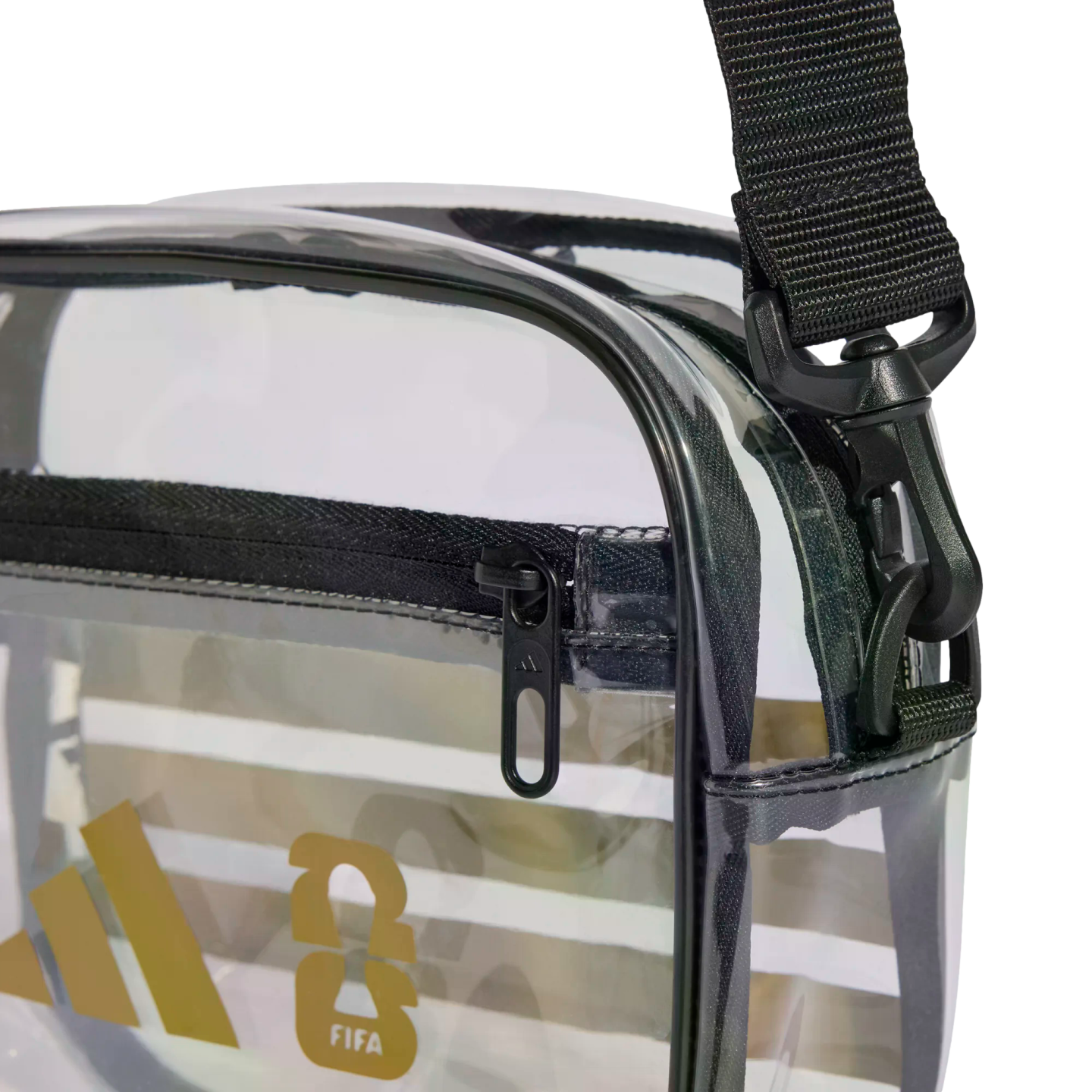 Close-up of a clear Adidas shoulder bag with black trim, a gold logo, and a black zipper. A black adjustable strap is attached with a plastic swivel hook.
