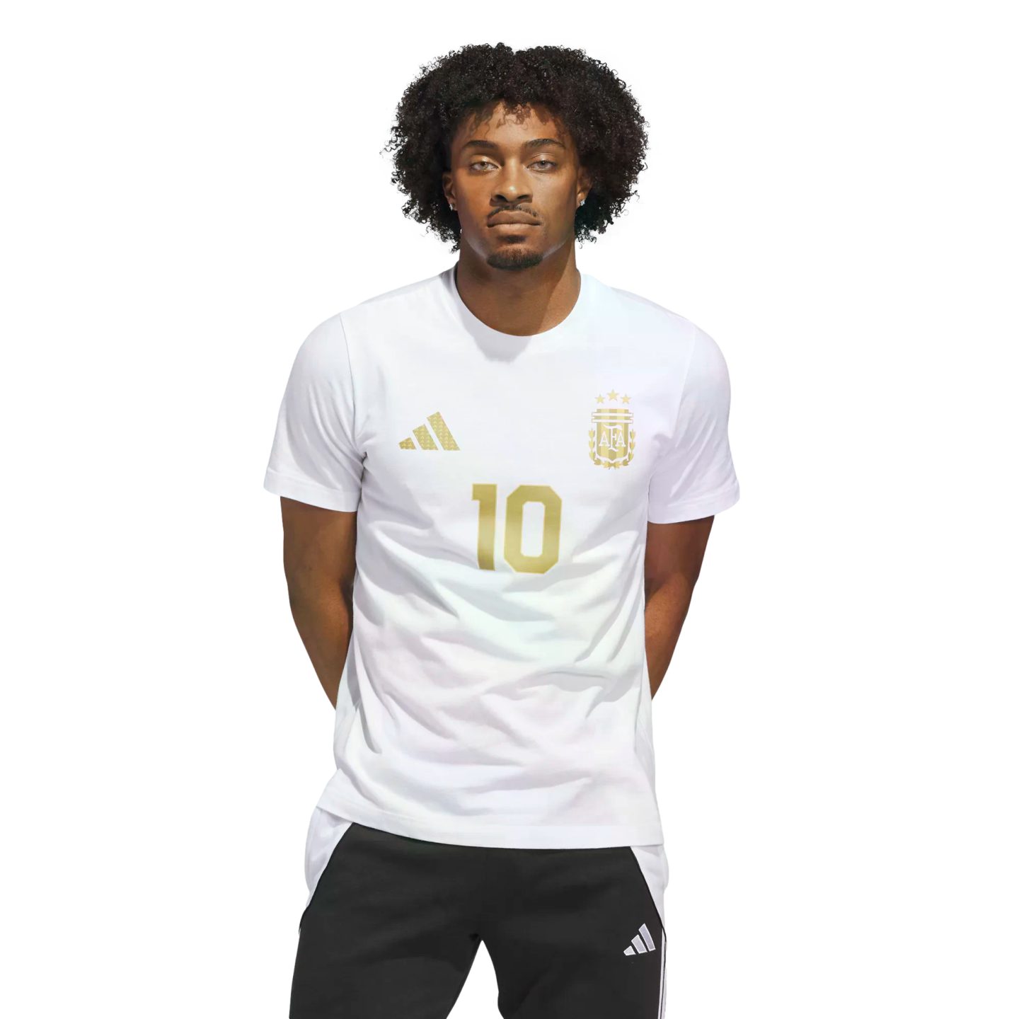 A young man with curly hair wearing a white Argentina jersey with gold number 10 and logos, standing against a black background.